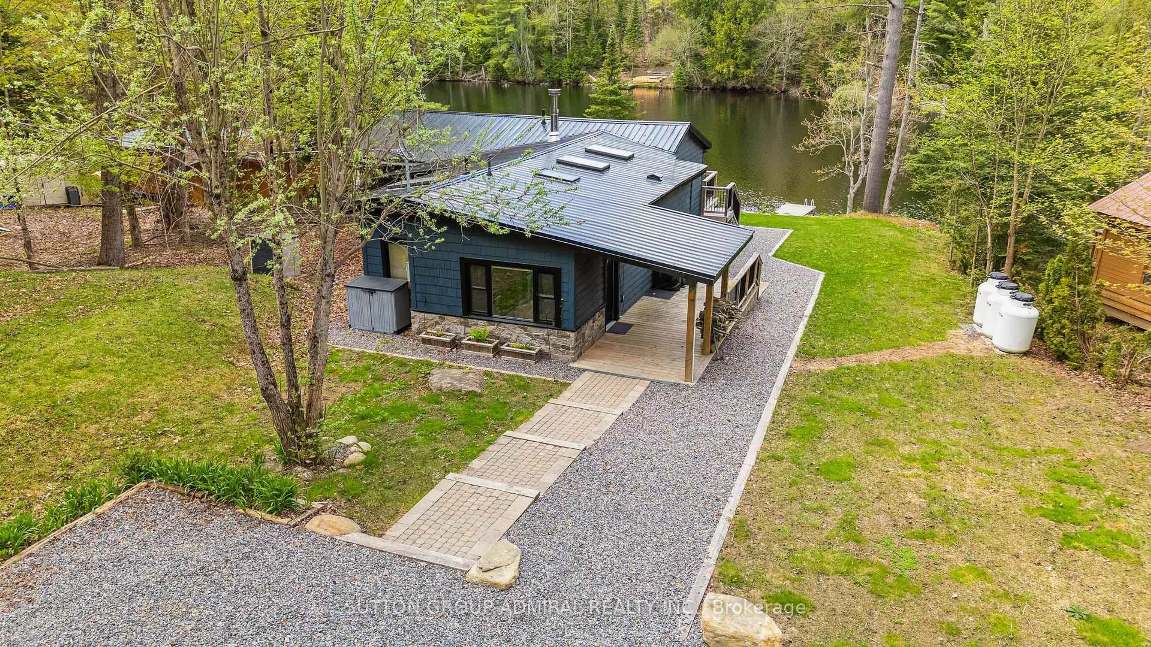 A pic from outside/outdoor area/front of a property/back of a property/a pic from drone, water/lake/river/ocean view for 1023 Kirkpatrick Lane, Bracebridge Ontario P1L 1X1