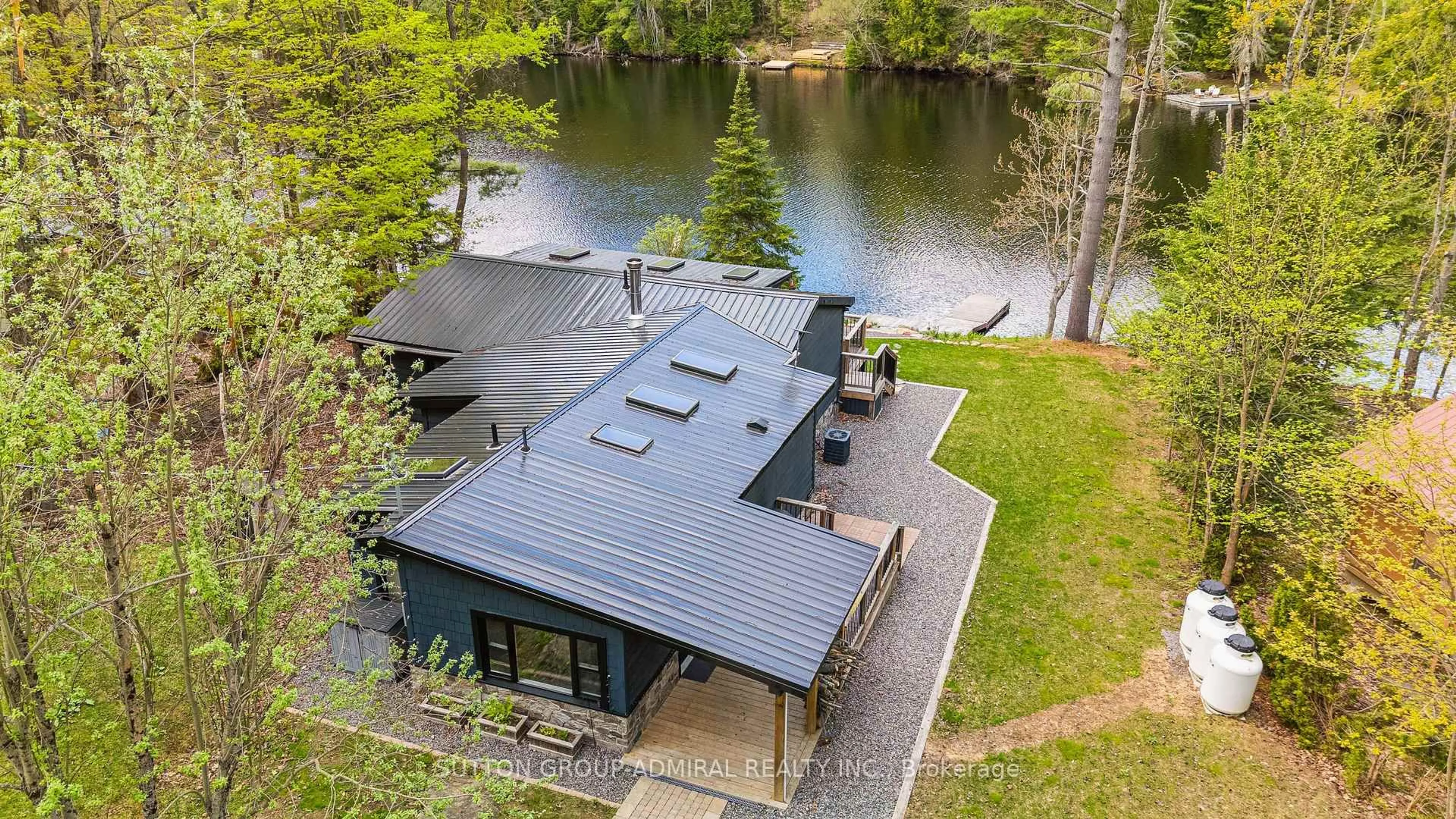 A pic from outside/outdoor area/front of a property/back of a property/a pic from drone, water/lake/river/ocean view for 1023 Kirkpatrick Lane, Bracebridge Ontario P1L 1X1