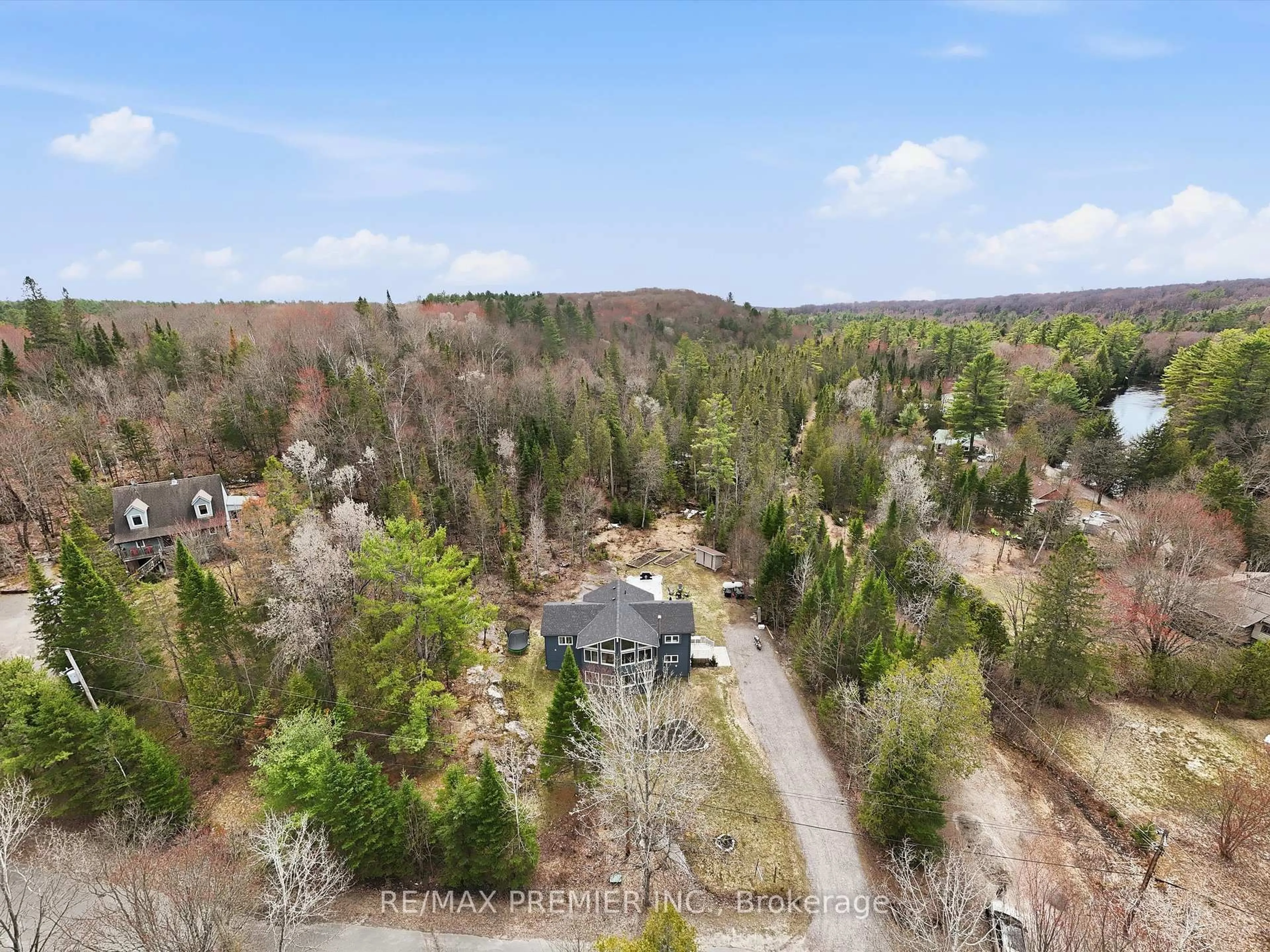 A pic from outside/outdoor area/front of a property/back of a property/a pic from drone, forest/trees view for 1131 Springdale Park Rd, Bracebridge Ontario P1L 1W9