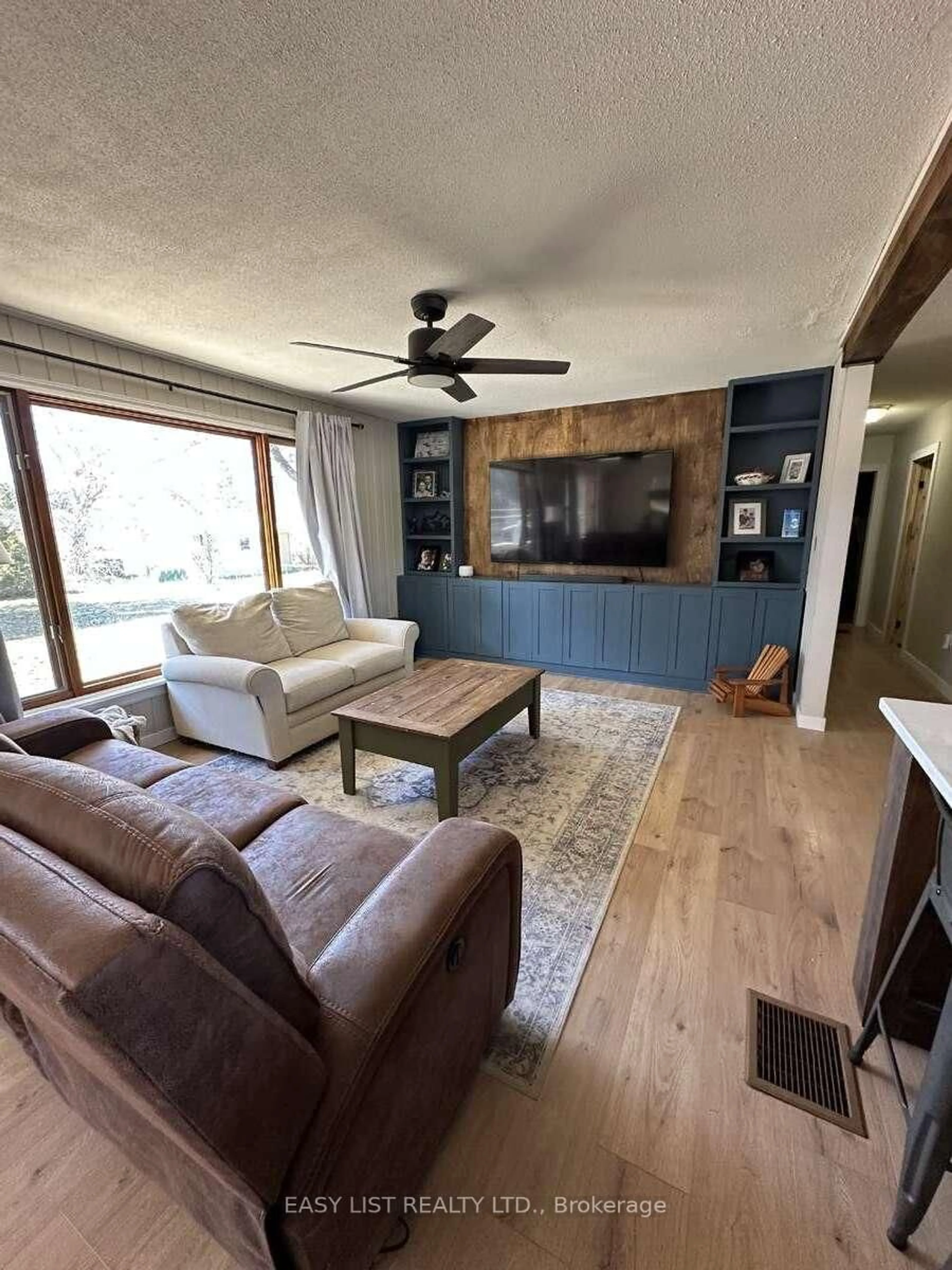 Living room with furniture, wood/laminate floor for 7 Fitz Ave, South River Ontario P0A 1X0