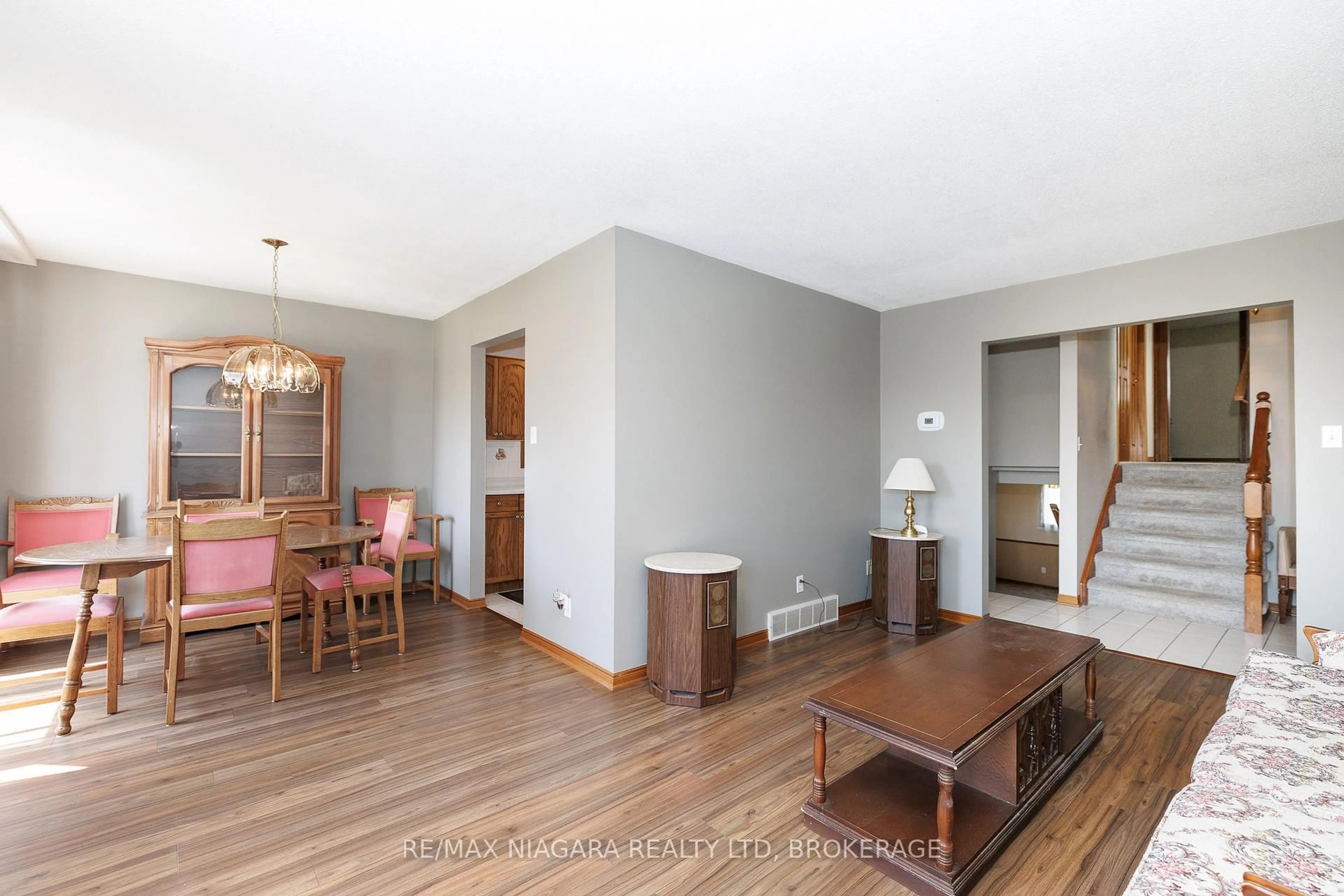 Living room with furniture, wood/laminate floor for 7821 Windfield St, Niagara Falls Ontario L2H 2X4