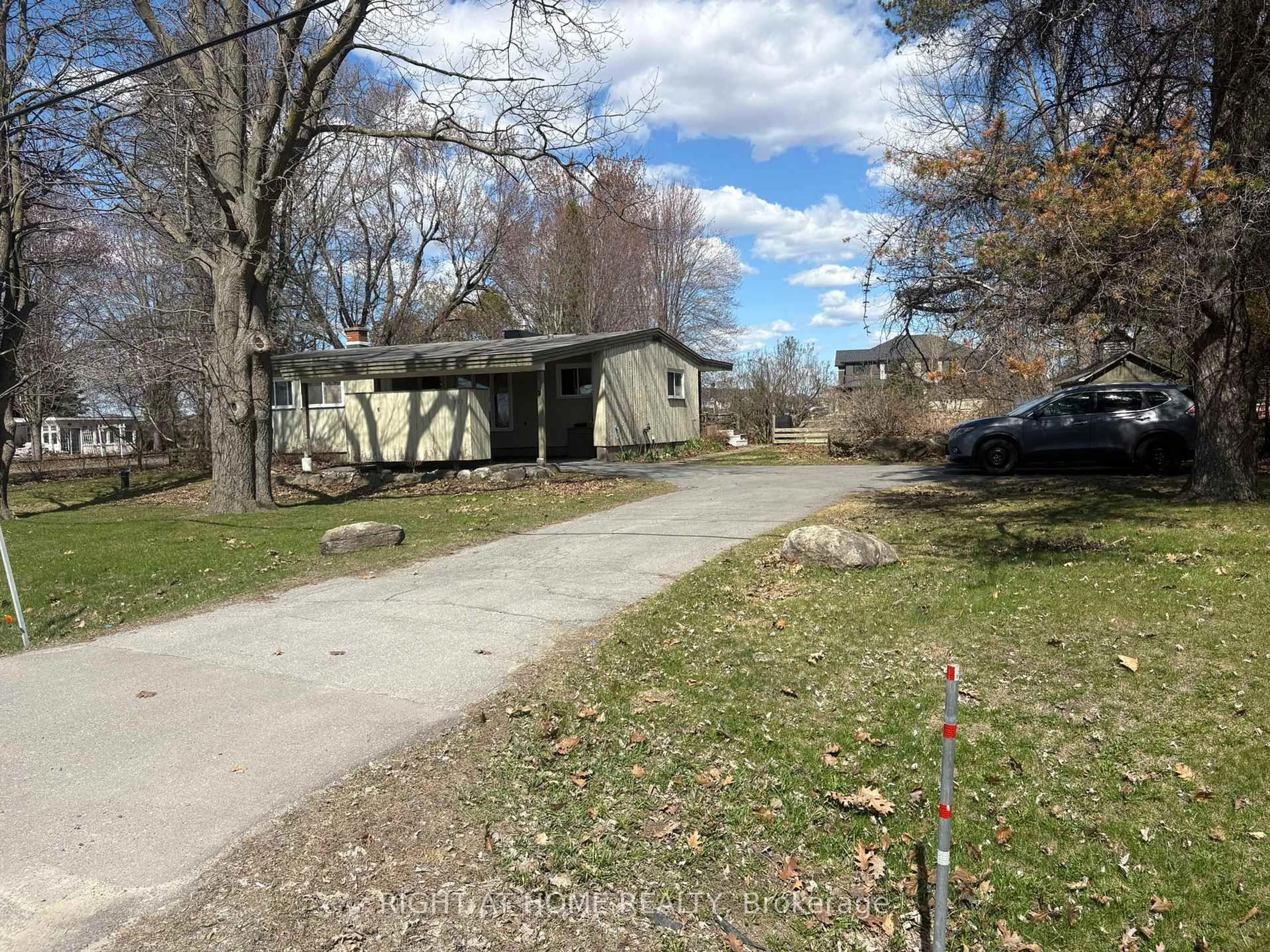 A pic from outside/outdoor area/front of a property/back of a property/a pic from drone, street for 793 River Rd, Manotick Ontario K4M 0T9