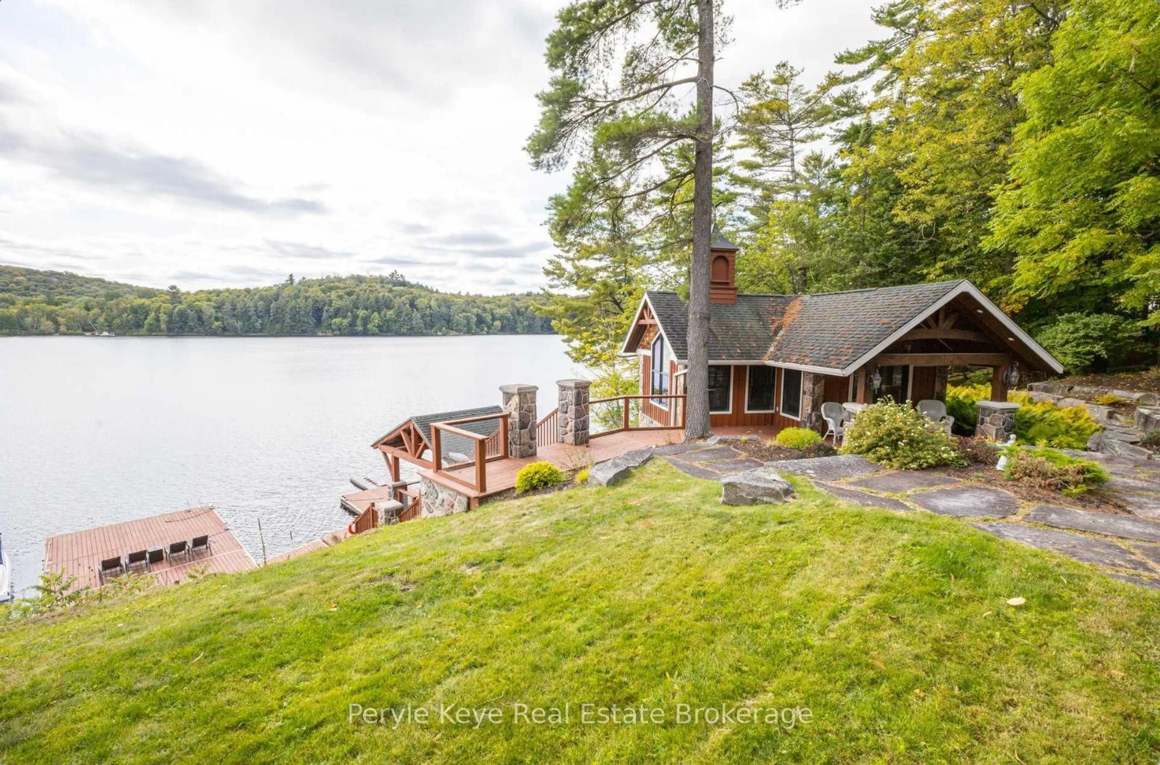 A pic from outside/outdoor area/front of a property/back of a property/a pic from drone, water/lake/river/ocean view for 247 South Dr, Huntsville Ontario P1H 2J2