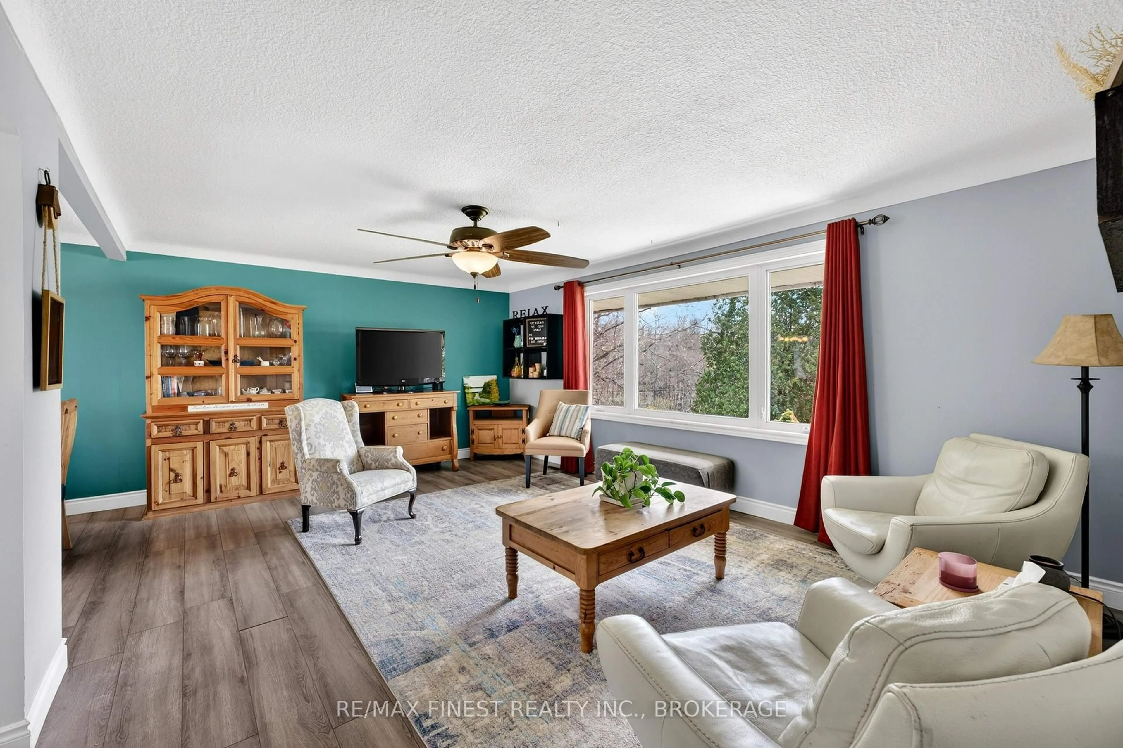 Living room with furniture, wood/laminate floor for 4333 Maple Dr, Verona Ontario K0H 2W0