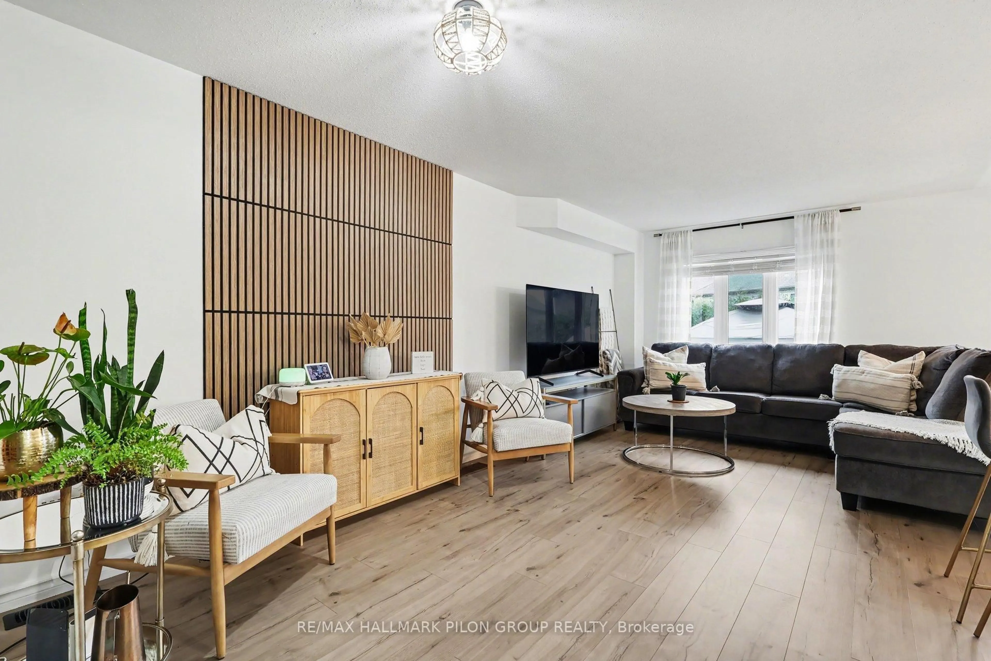 Living room with furniture, wood/laminate floor for 218 Rolling Meadow Cres, Orleans Ontario K1W 0B1