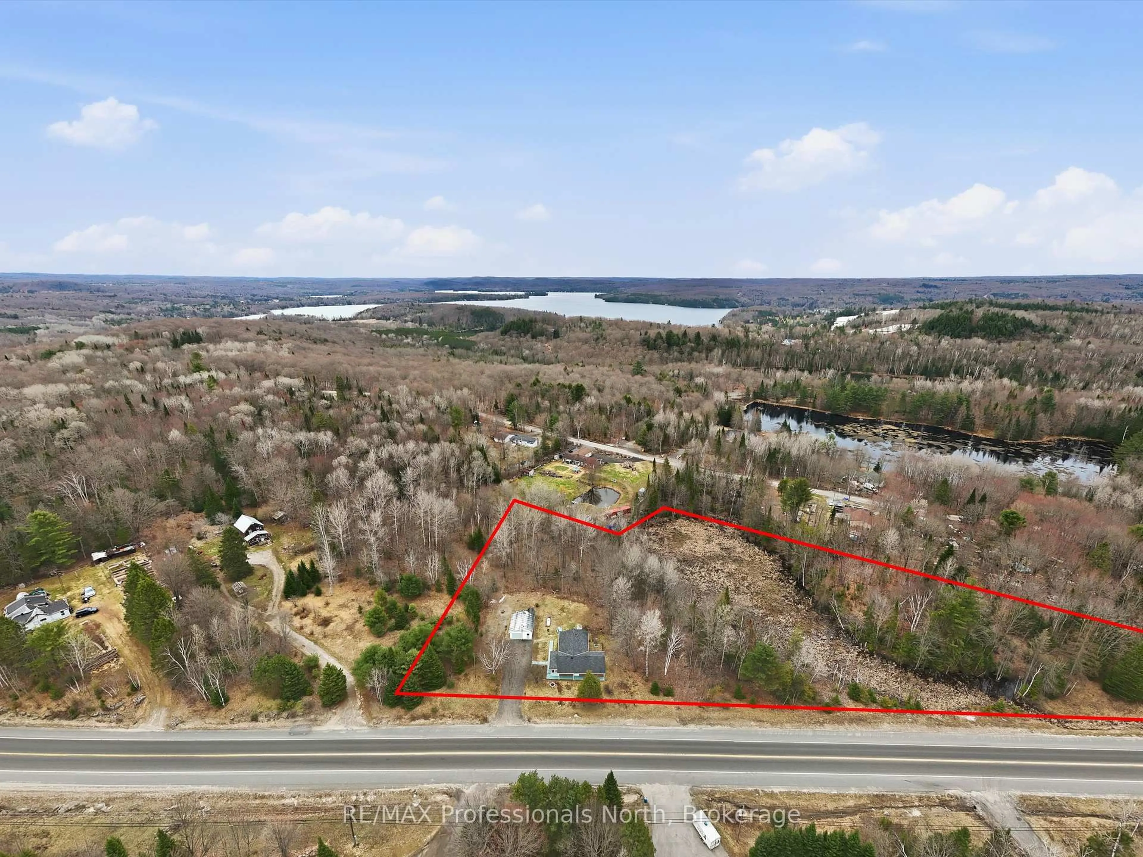 A pic from outside/outdoor area/front of a property/back of a property/a pic from drone, water/lake/river/ocean view for 1671 60 Highway, Huntsville Ontario P1H 1A2