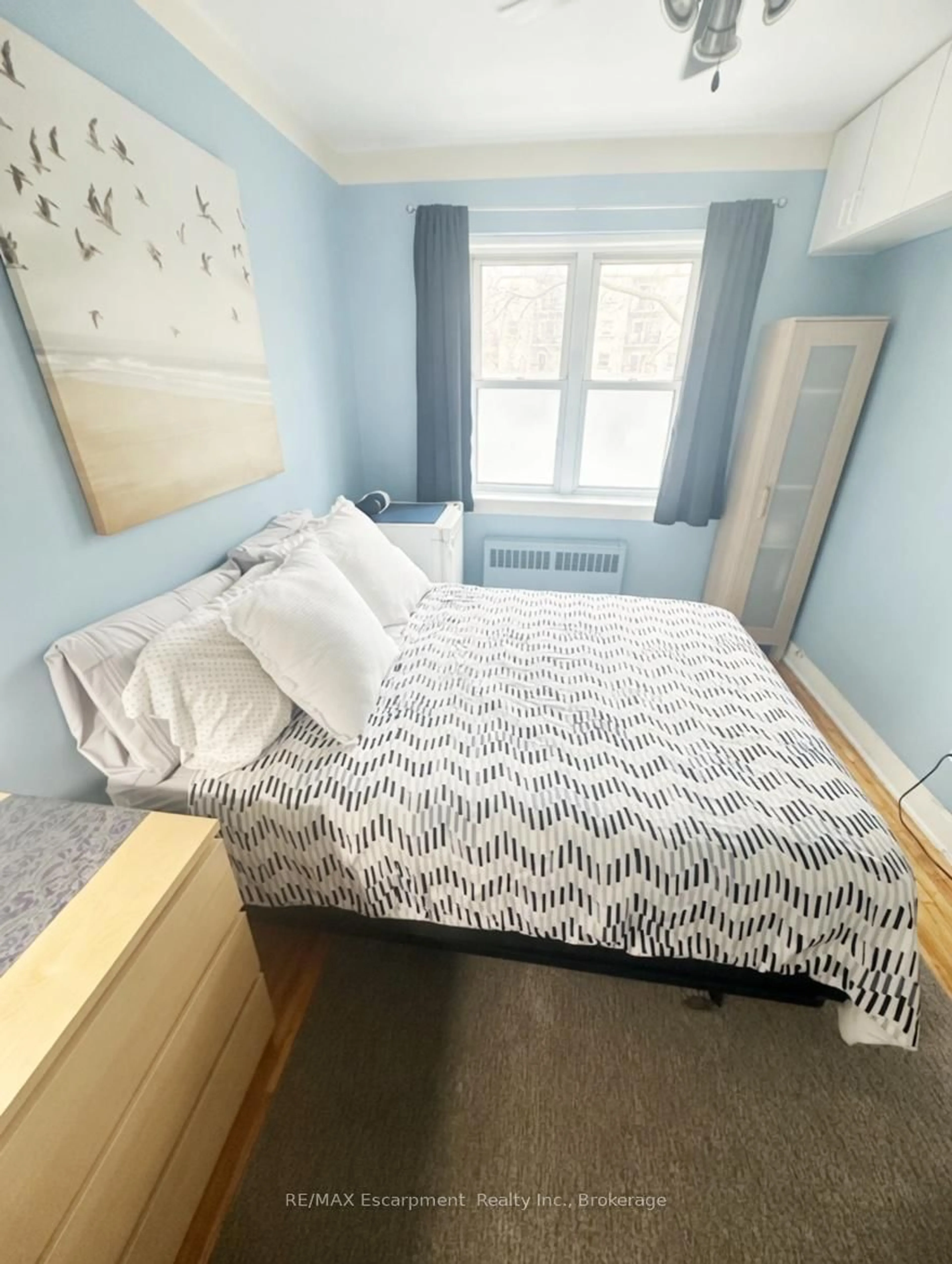Bedroom with bed, floor is not visible for 60 Robinson St #305, Hamilton Ontario L8P 1Y9