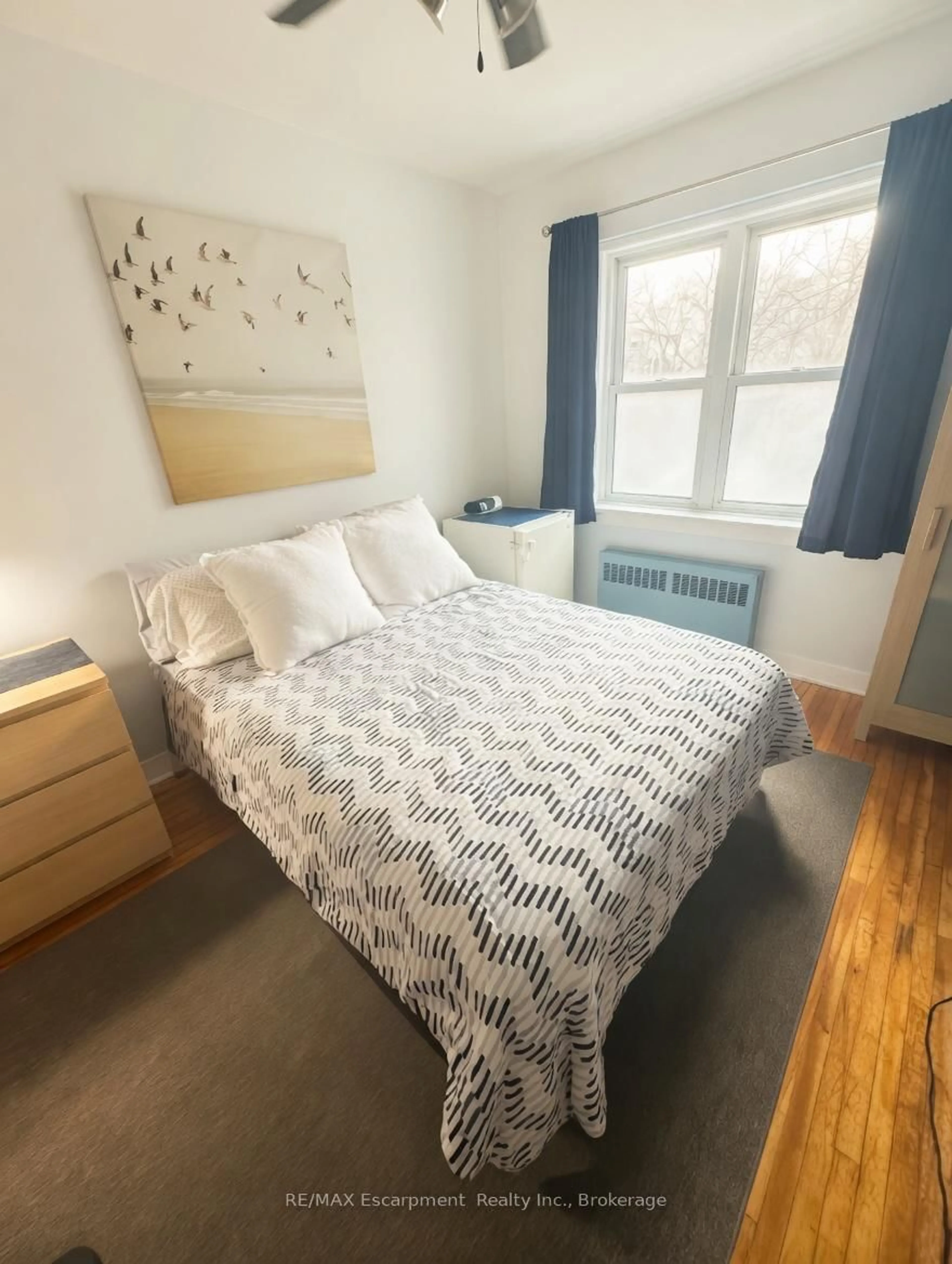 Bedroom with bed, wood/laminate floor for 60 Robinson St #305, Hamilton Ontario L8P 1Y9