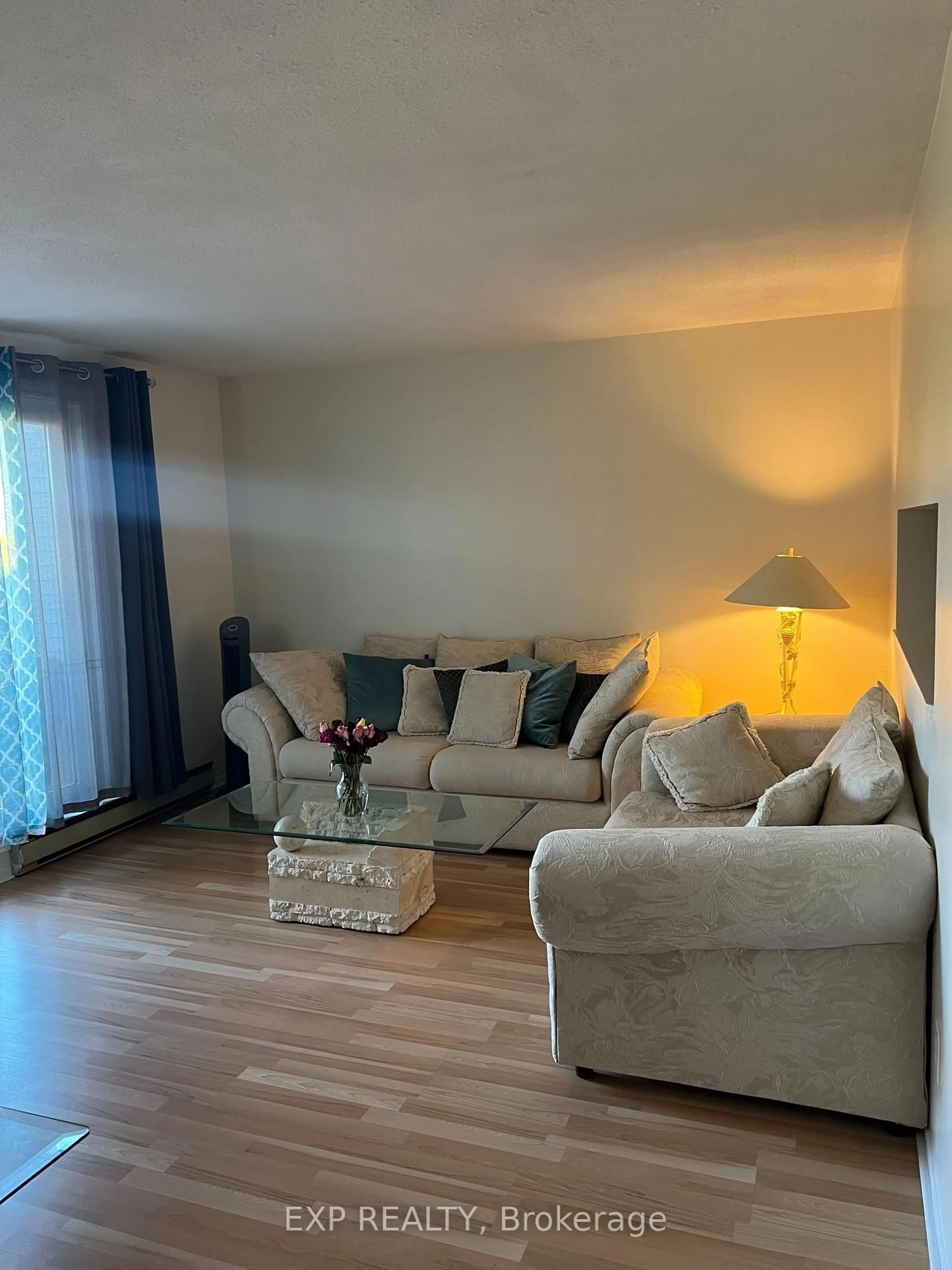 Living room with furniture, wood/laminate floor for 216 Viewmount Dr #407, Ottawa Ontario K2E 7X4