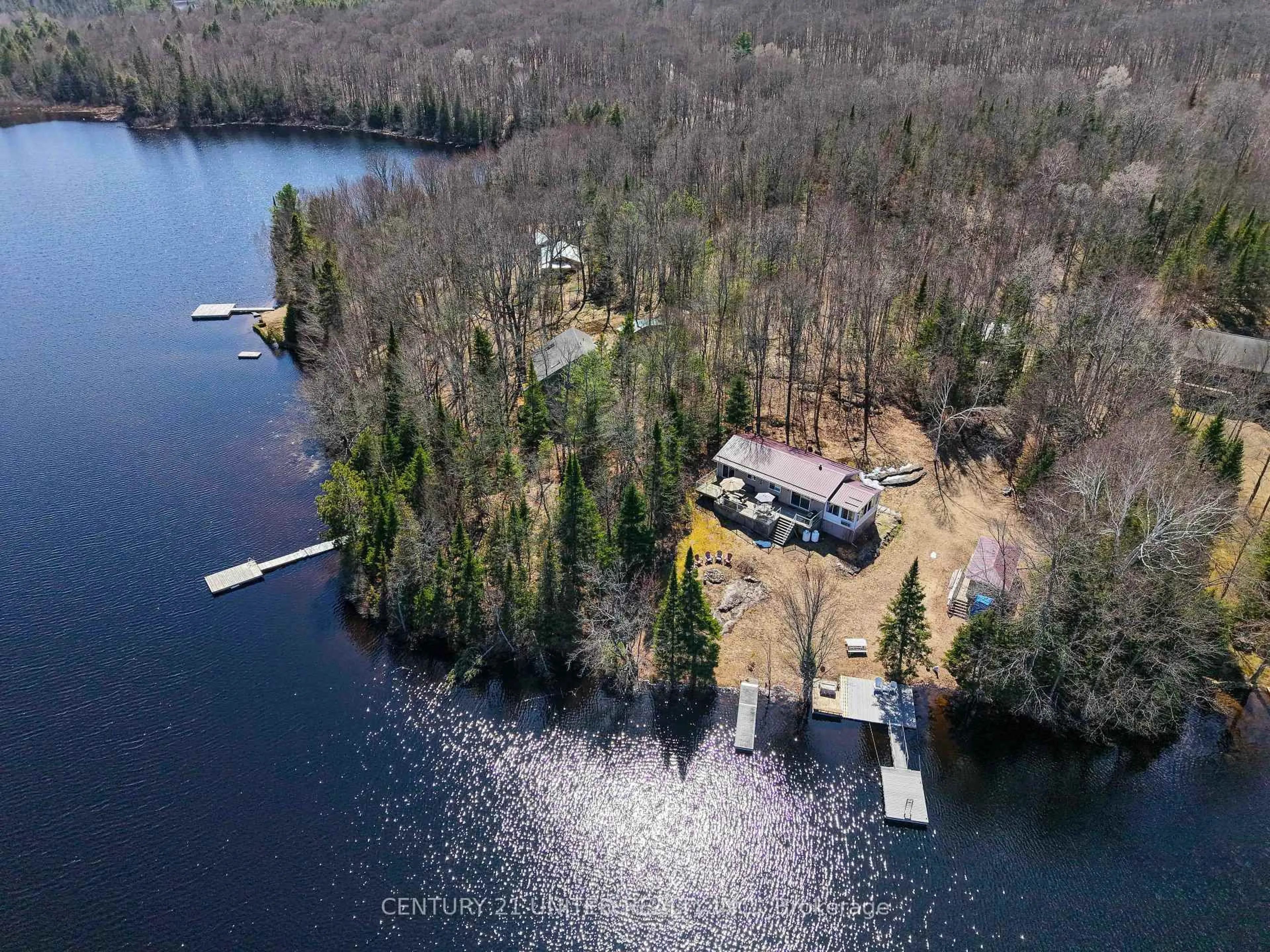 A pic from outside/outdoor area/front of a property/back of a property/a pic from drone, water/lake/river/ocean view for 1047 Redwood Lane, Highlands East Ontario K0L 1C0