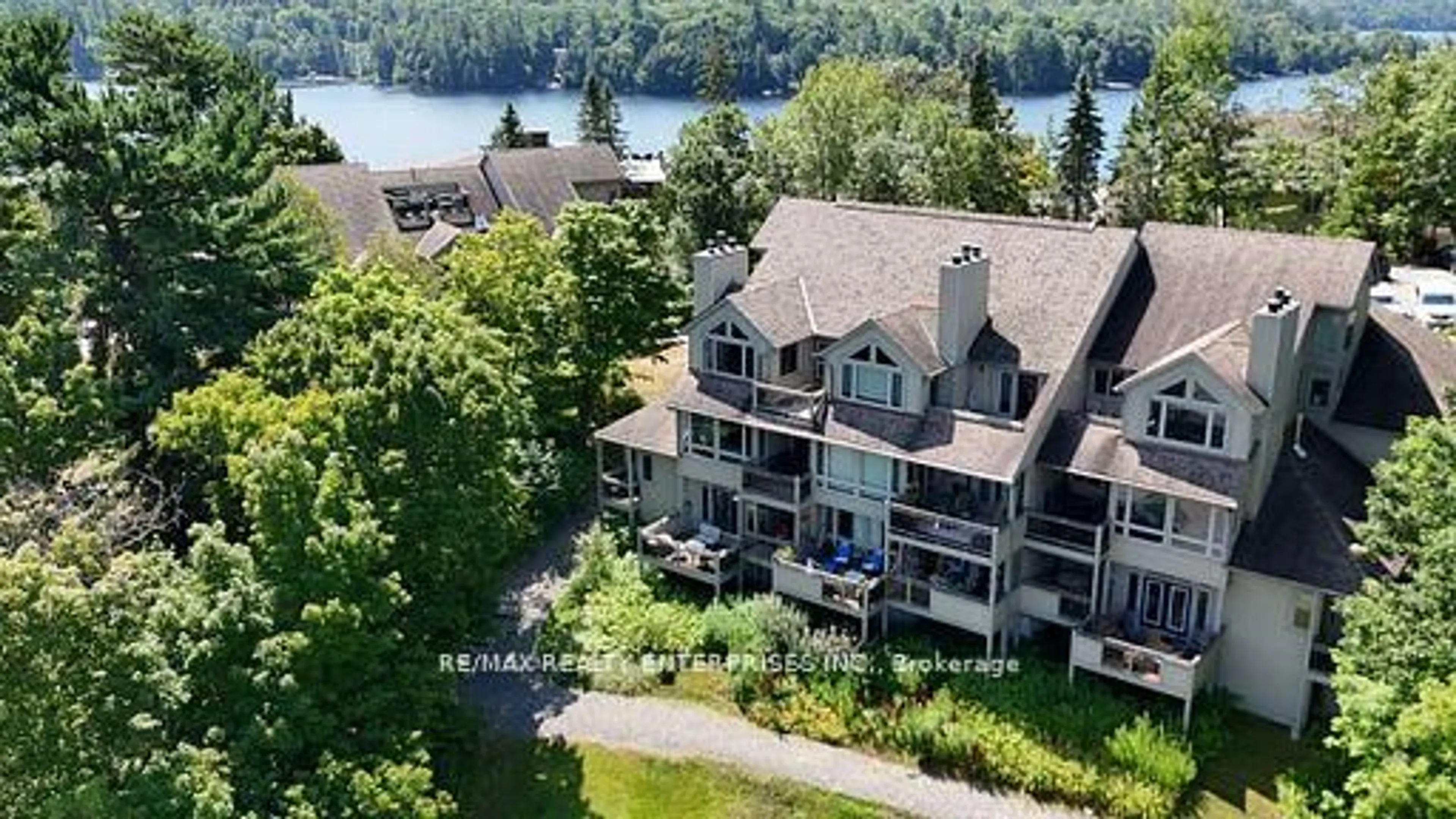 A pic from outside/outdoor area/front of a property/back of a property/a pic from drone, water/lake/river/ocean view for 811 Grandview Hilltop Dr #8, Huntsville Ontario P1H 2J5