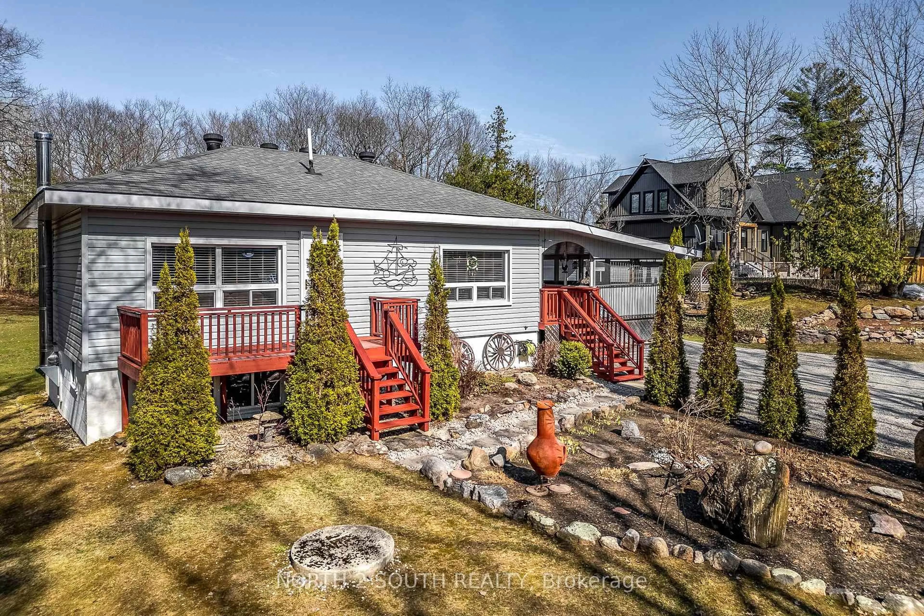 A pic from outside/outdoor area/front of a property/back of a property/a pic from drone, street for 2390 Honey Harbour Rd, Georgian Bay Ontario P0E 1E0