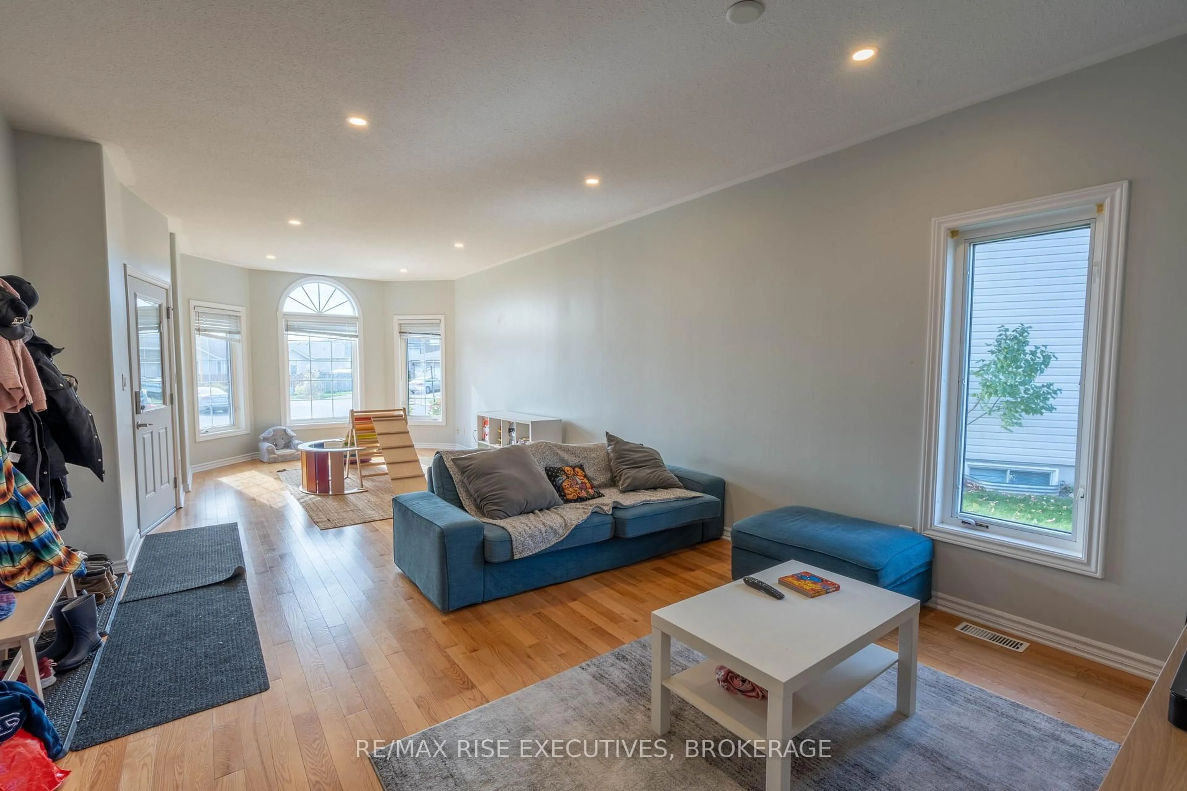 Living room with furniture, wood/laminate floor for 105 Aaron Pl, Loyalist Ontario K7N 2A1