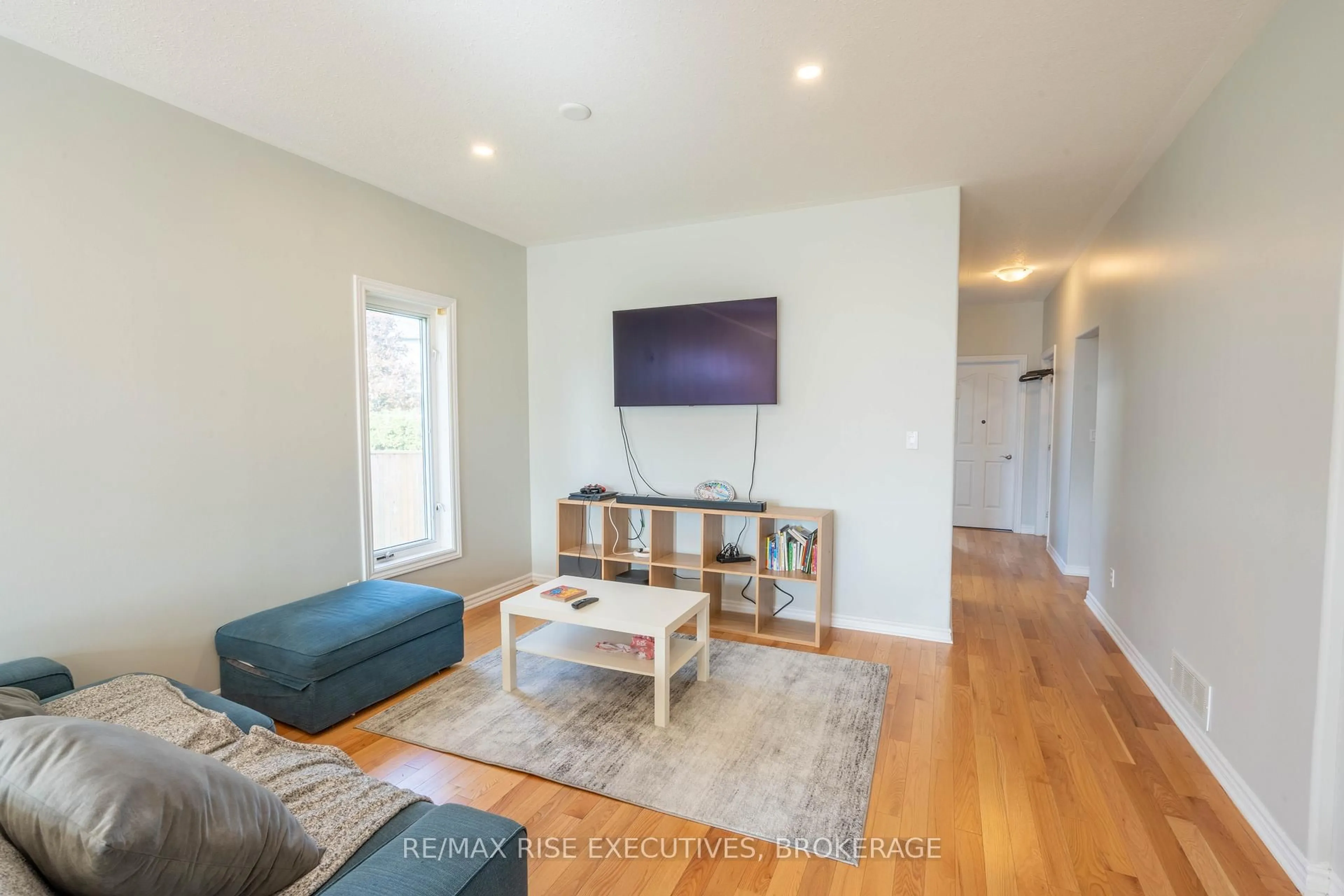 Living room with furniture, wood/laminate floor for 105 Aaron Pl, Loyalist Ontario K7N 2A1