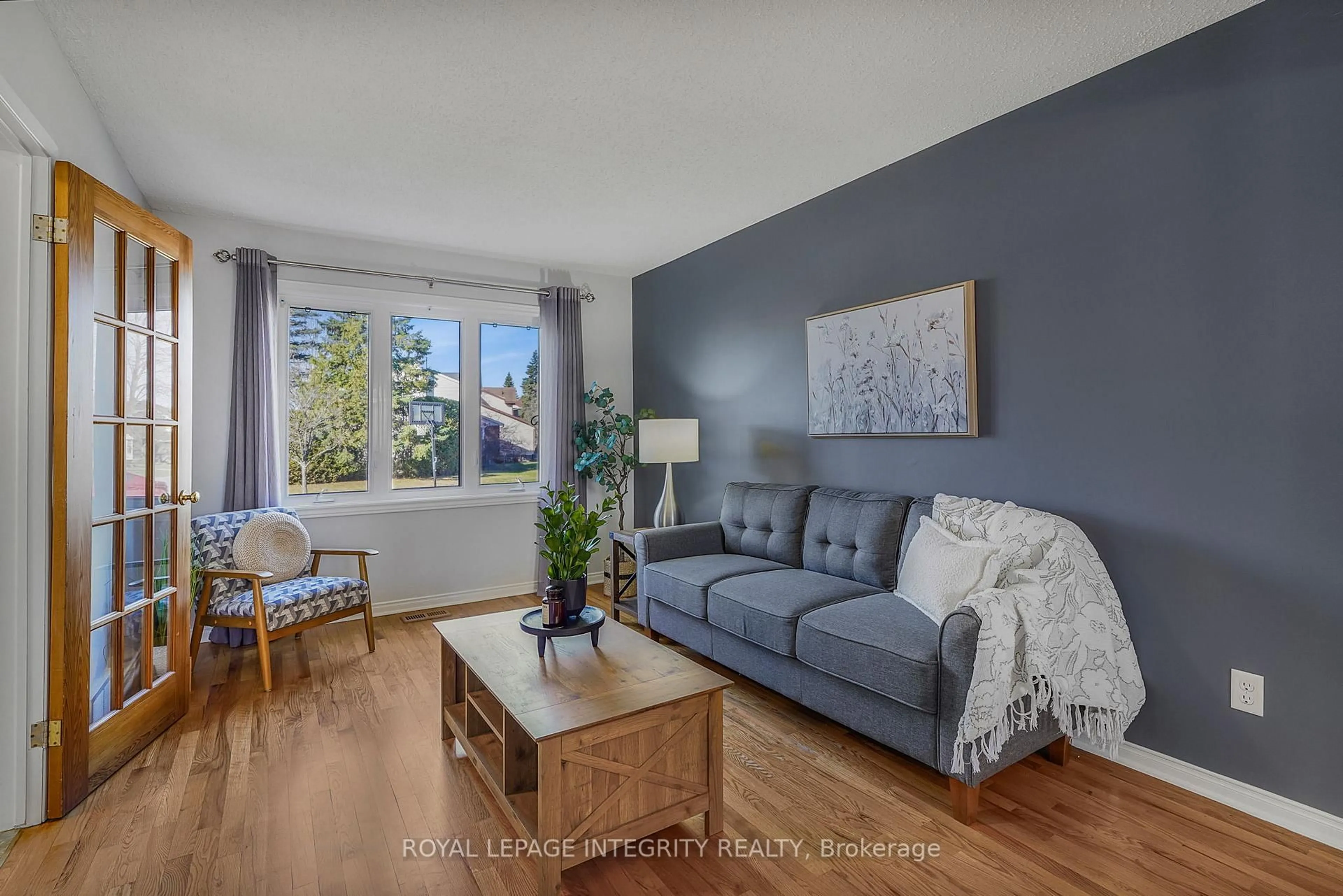 Living room with furniture, wood/laminate floor for 641 Apollo Way, Ottawa Ontario K4A 1T5