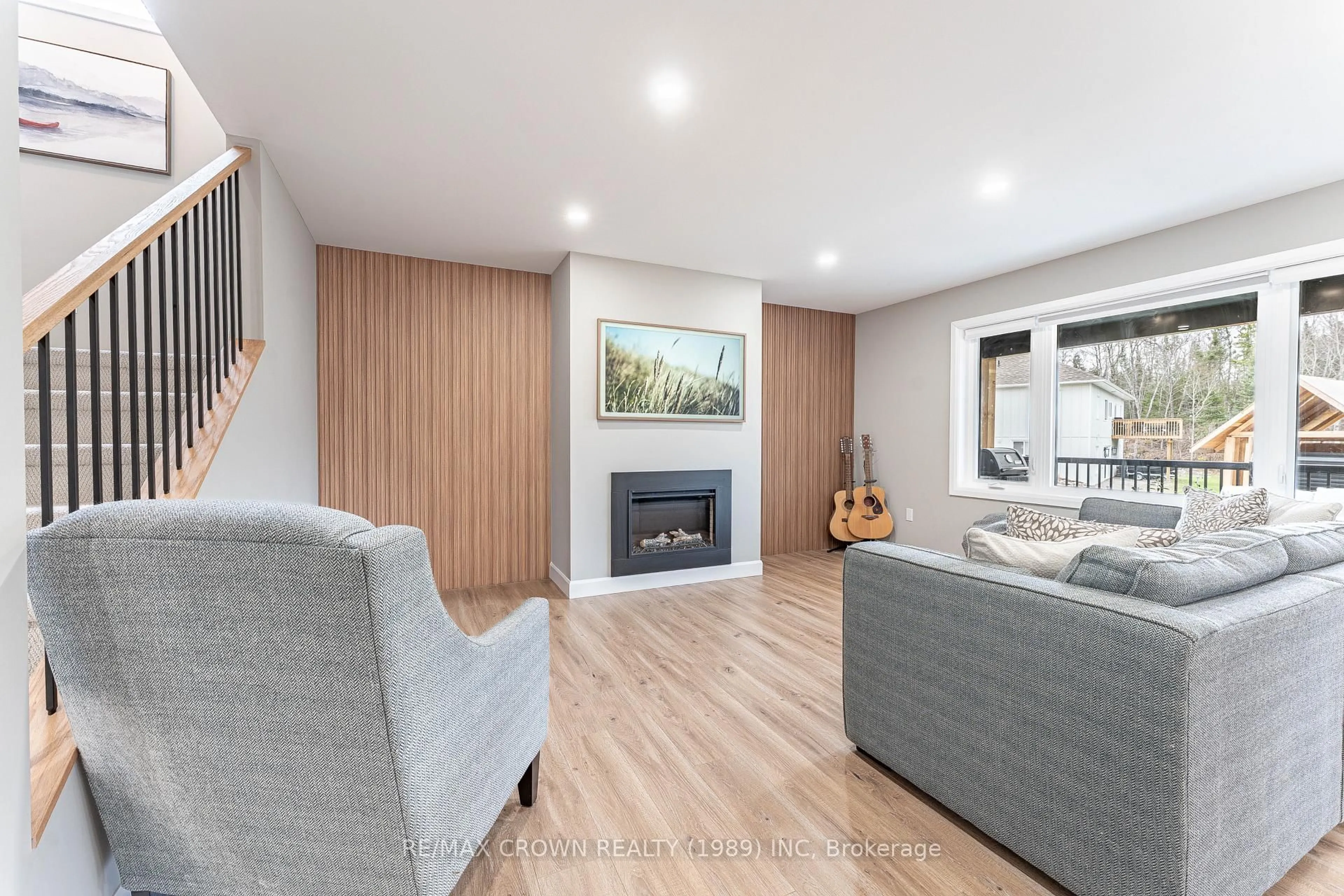 Living room with furniture, wood/laminate floor for 121 Golf Course Rd, Callander Ontario P0H 1H0