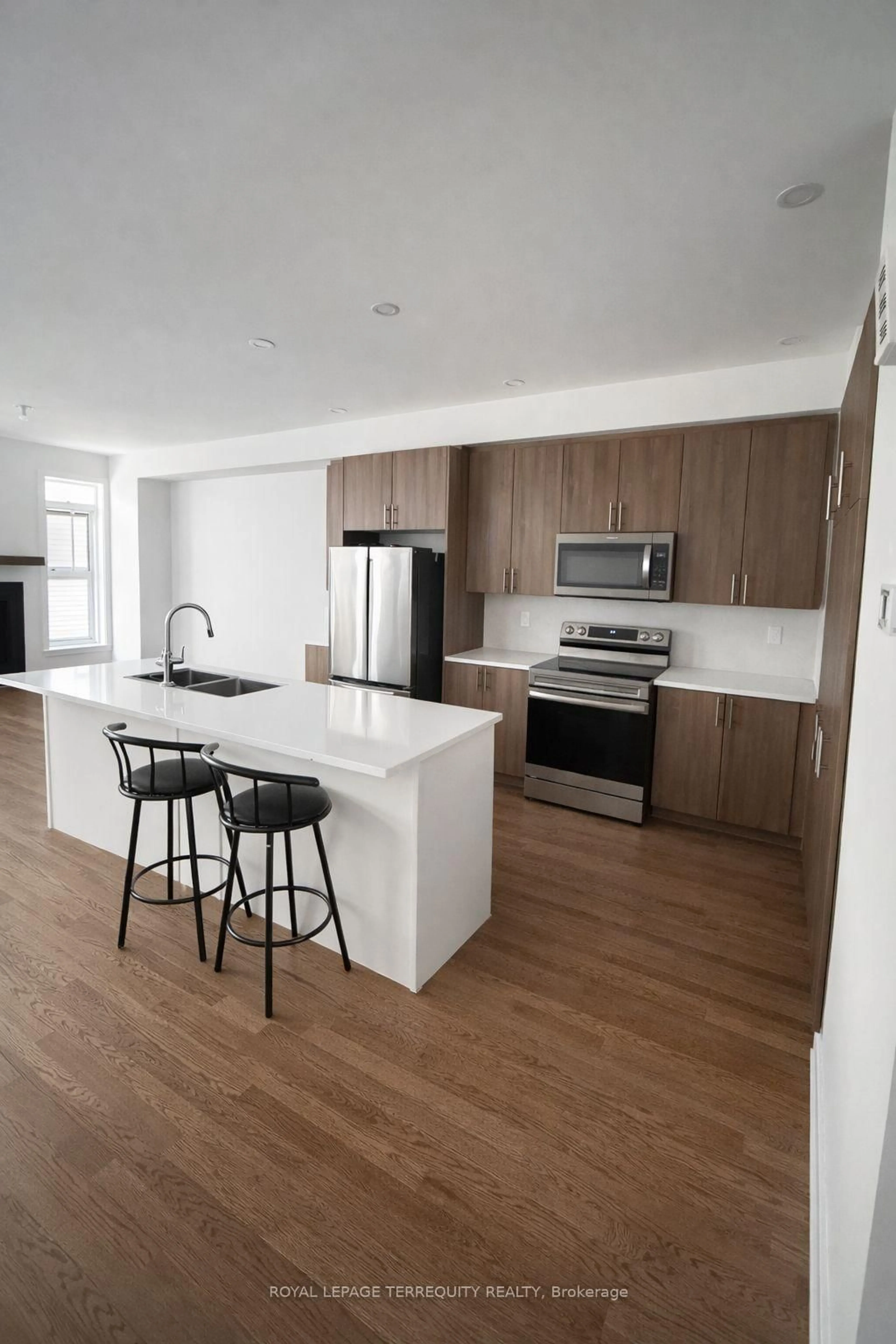 Open concept kitchen, wood/laminate floor for 74 Nettle Cres, Ottawa Ontario K1T 0W9