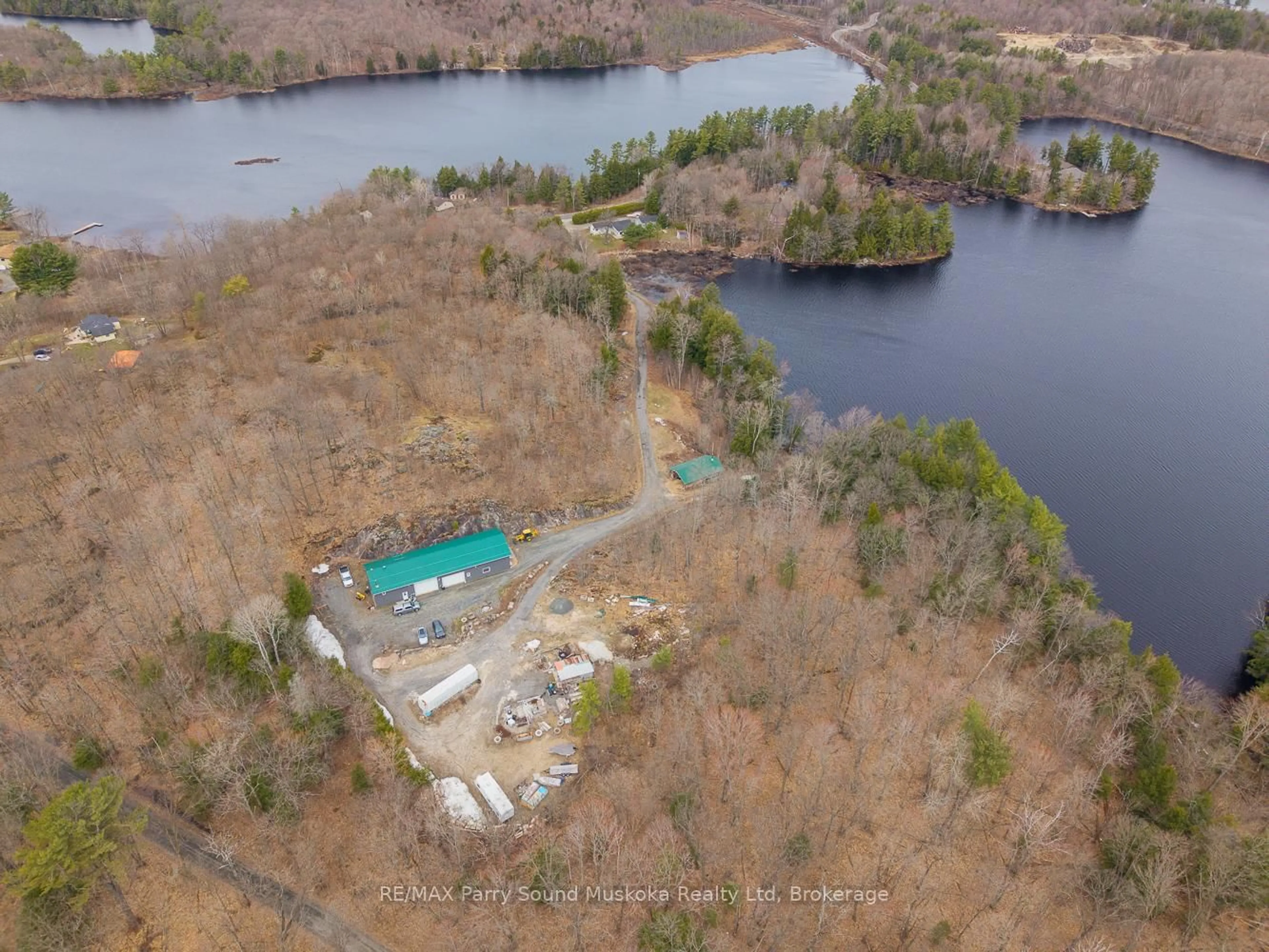 A pic from outside/outdoor area/front of a property/back of a property/a pic from drone, water/lake/river/ocean view for 92 Blue Lake Rd, Seguin Ontario P2A 2W8