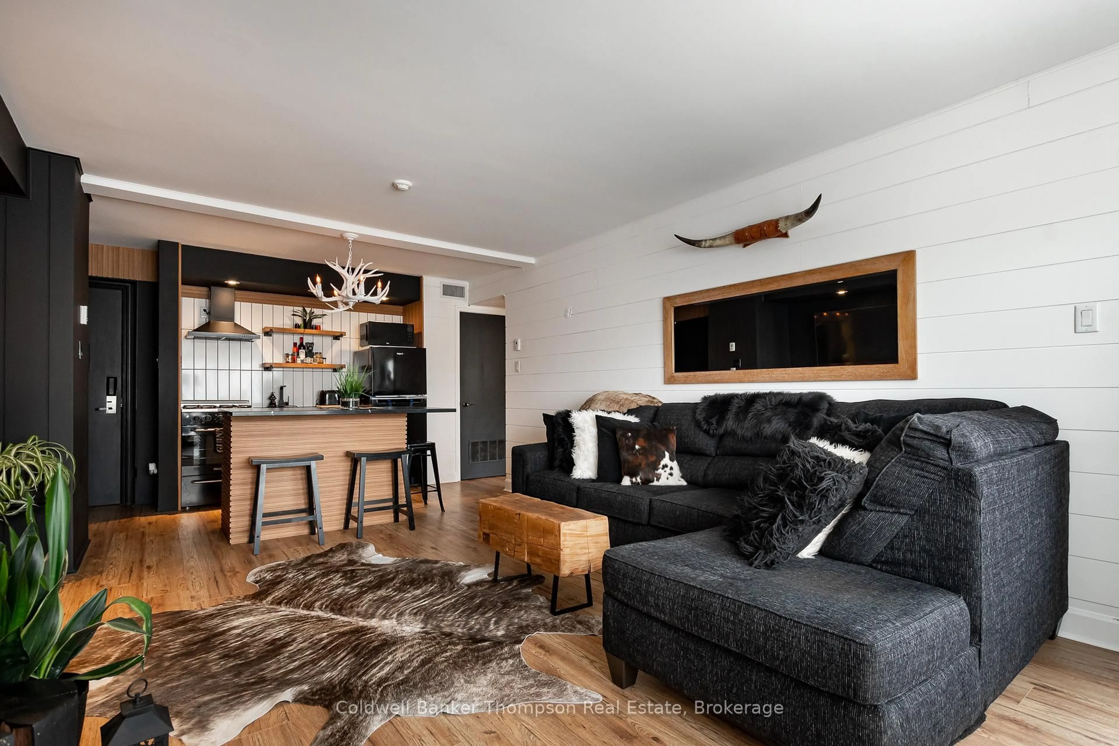 Living room with furniture, wood/laminate floor for 1235 Deerhurst Summit Dr #54-301, Huntsville Ontario P1H 1A9