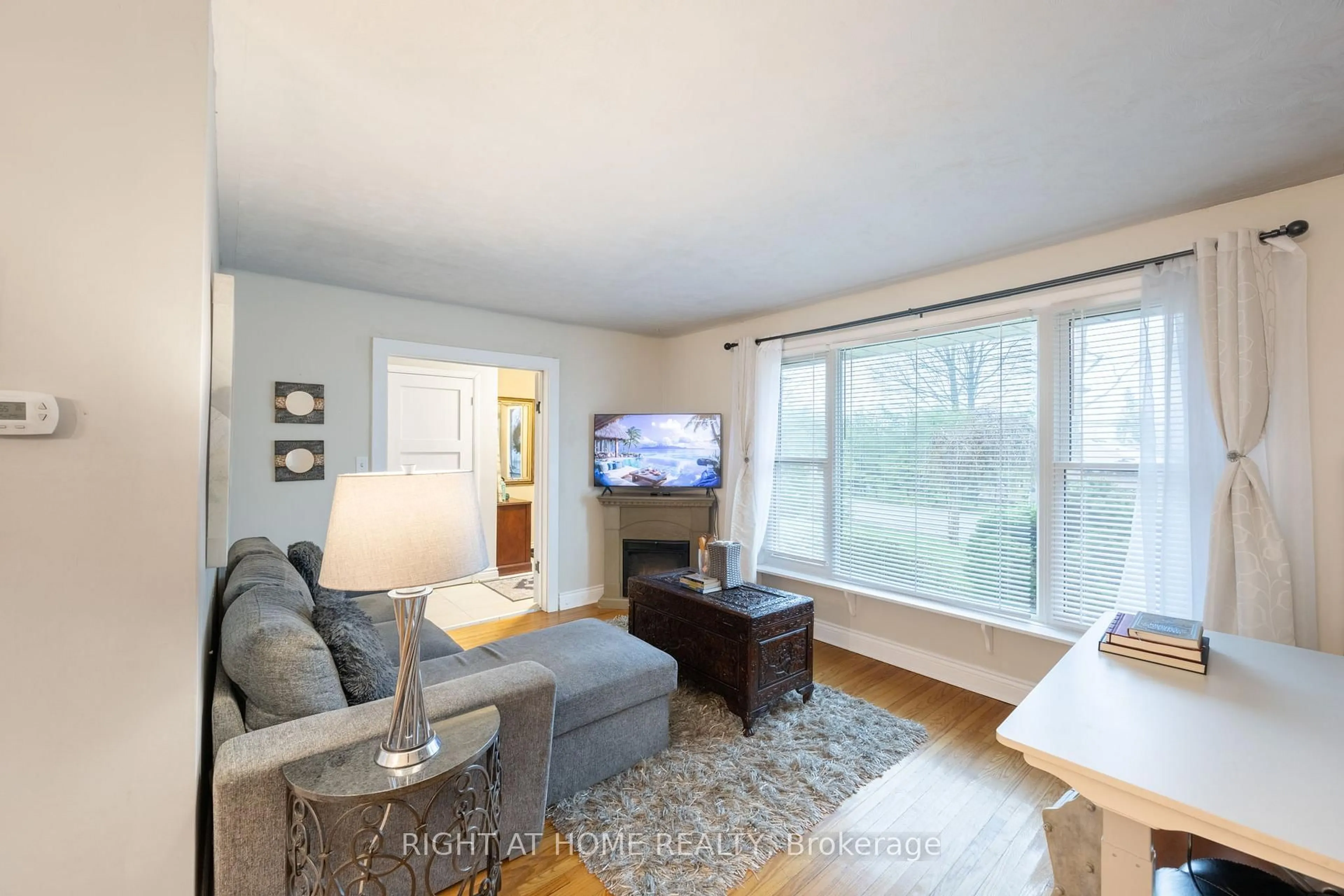 Living room with furniture, wood/laminate floor for 323 Lindan Ave, Selwyn Ontario K9L 1K9