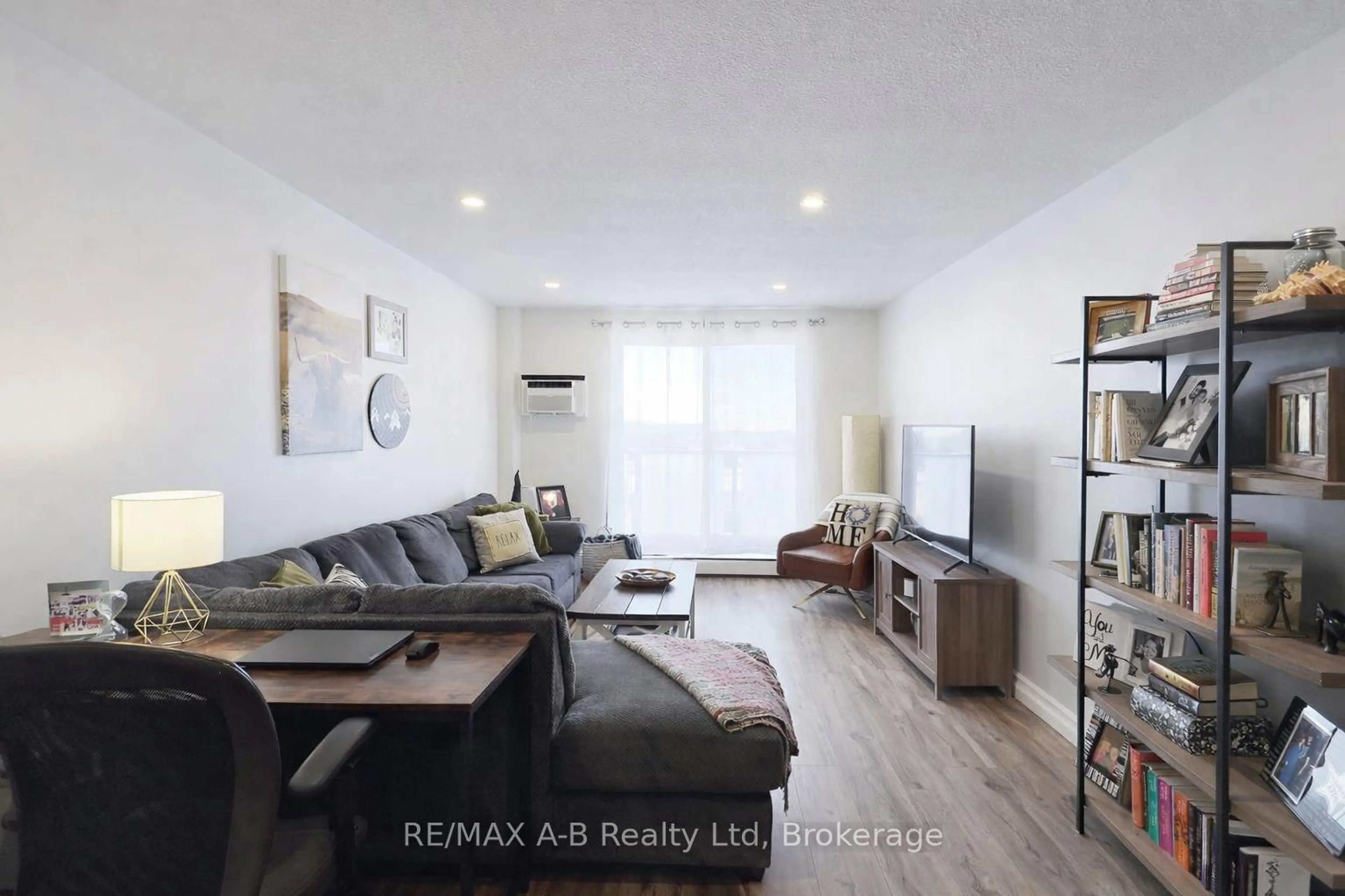 Living room with furniture, wood/laminate floor for 583 Mornington Ave #1005, London East Ontario N5Y 3E9