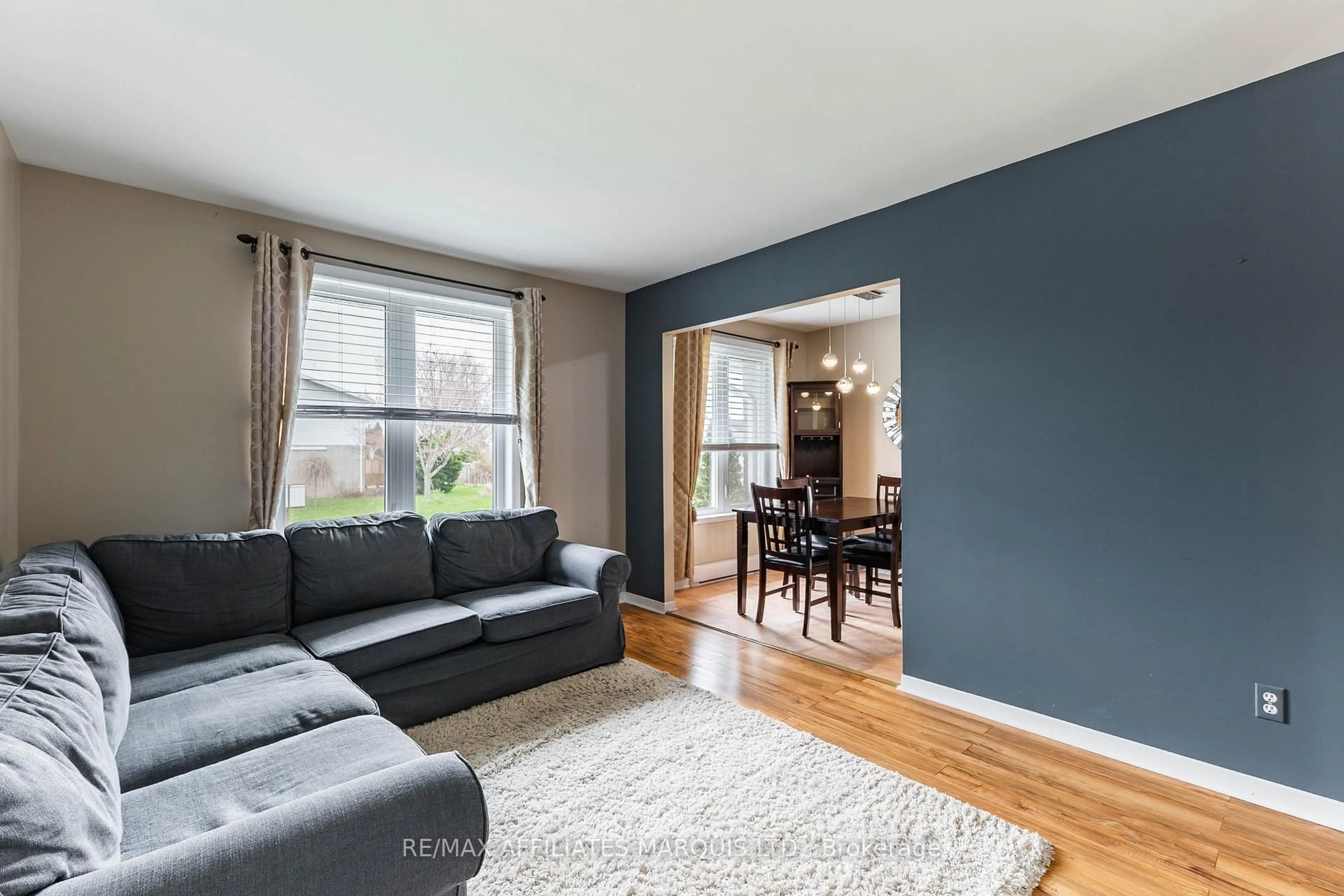 Living room with furniture, wood/laminate floor for 1754 Branch Dr, Cornwall Ontario K6J 5S6