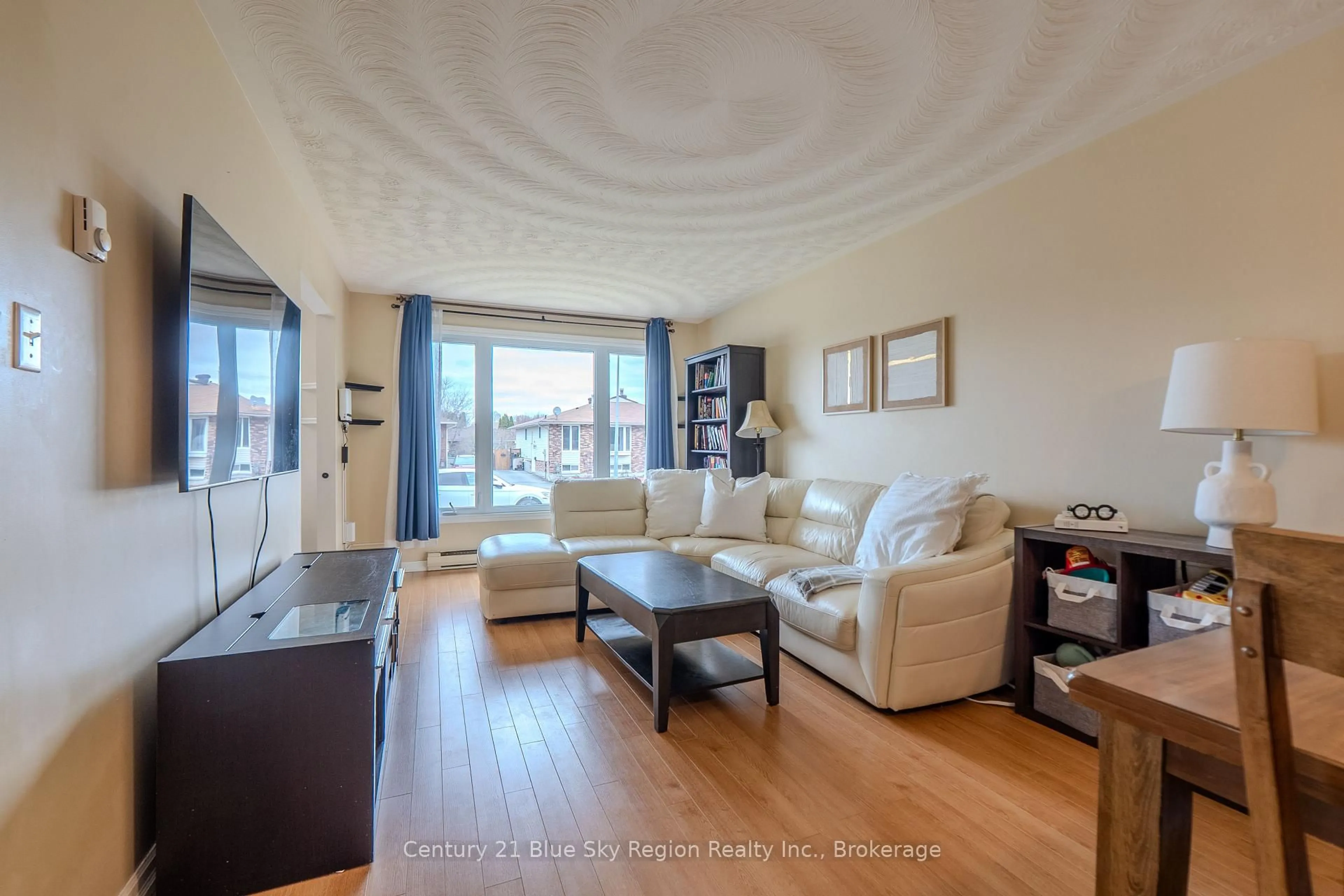 Living room with furniture, wood/laminate floor for 30 Harris Dr, North Bay Ontario P1A 3Z2