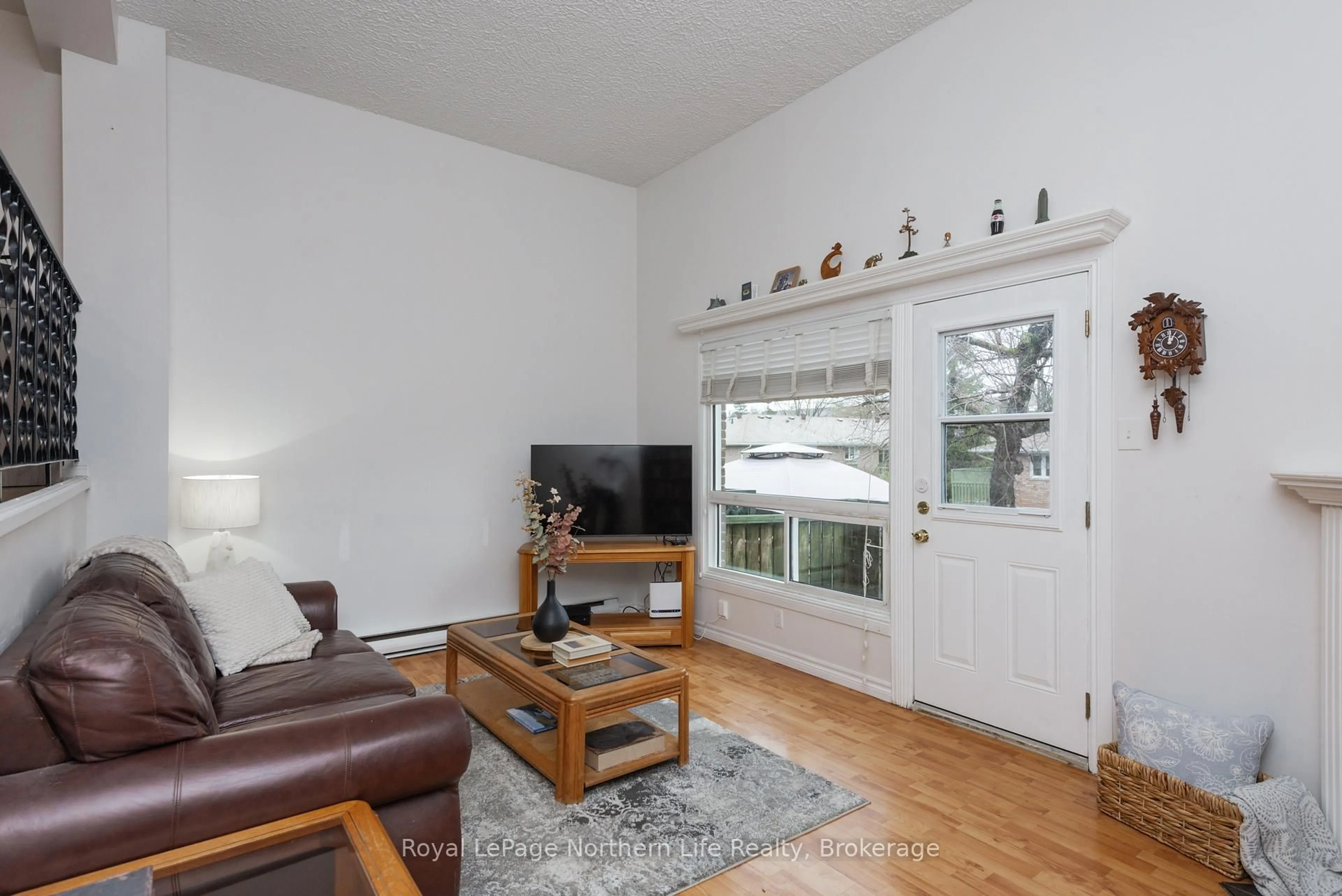 Living room with furniture, wood/laminate floor for 644 Lakeshore Dr #28, North Bay Ontario P1A 3N6