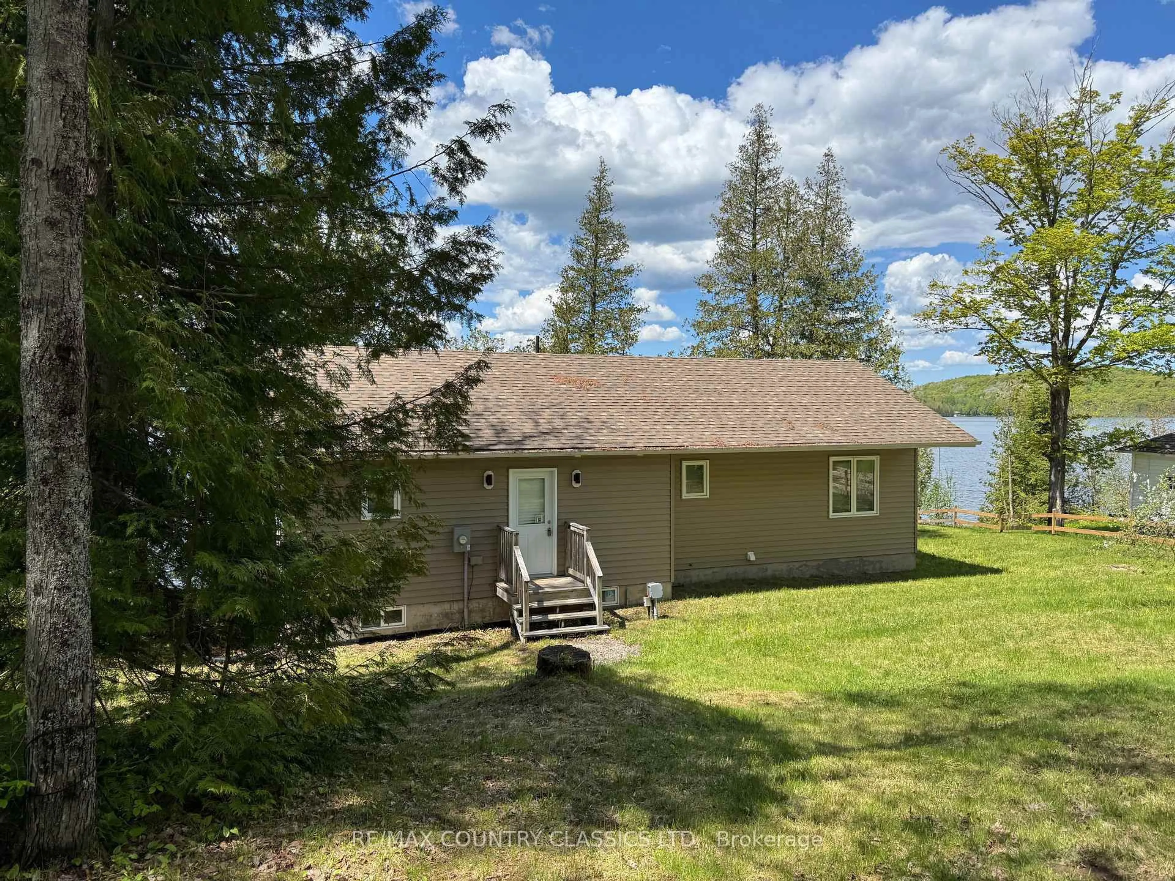 A pic from outside/outdoor area/front of a property/back of a property/a pic from drone, water/lake/river/ocean view for 27241 Highway 28, Highlands East Ontario K0L 1M0