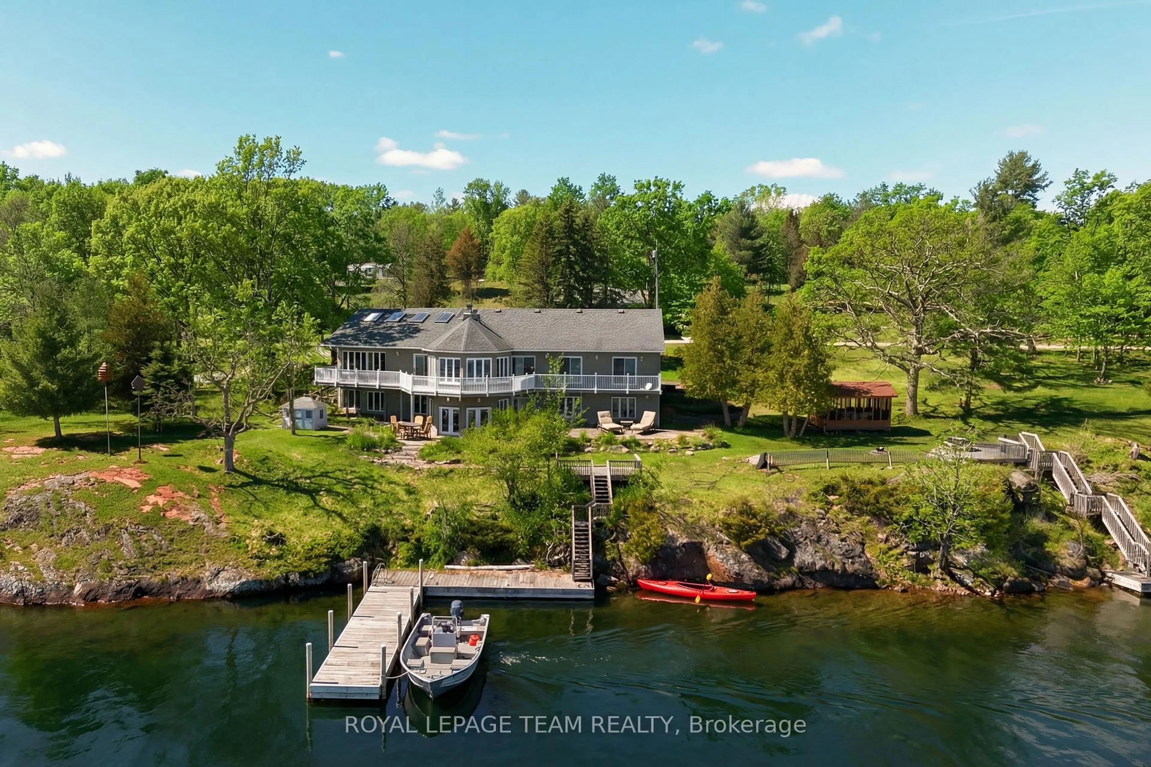 A pic from outside/outdoor area/front of a property/back of a property/a pic from drone, water/lake/river/ocean view for 605 Big Rideau North Shore Rd, Perth Ontario K7H 3C5