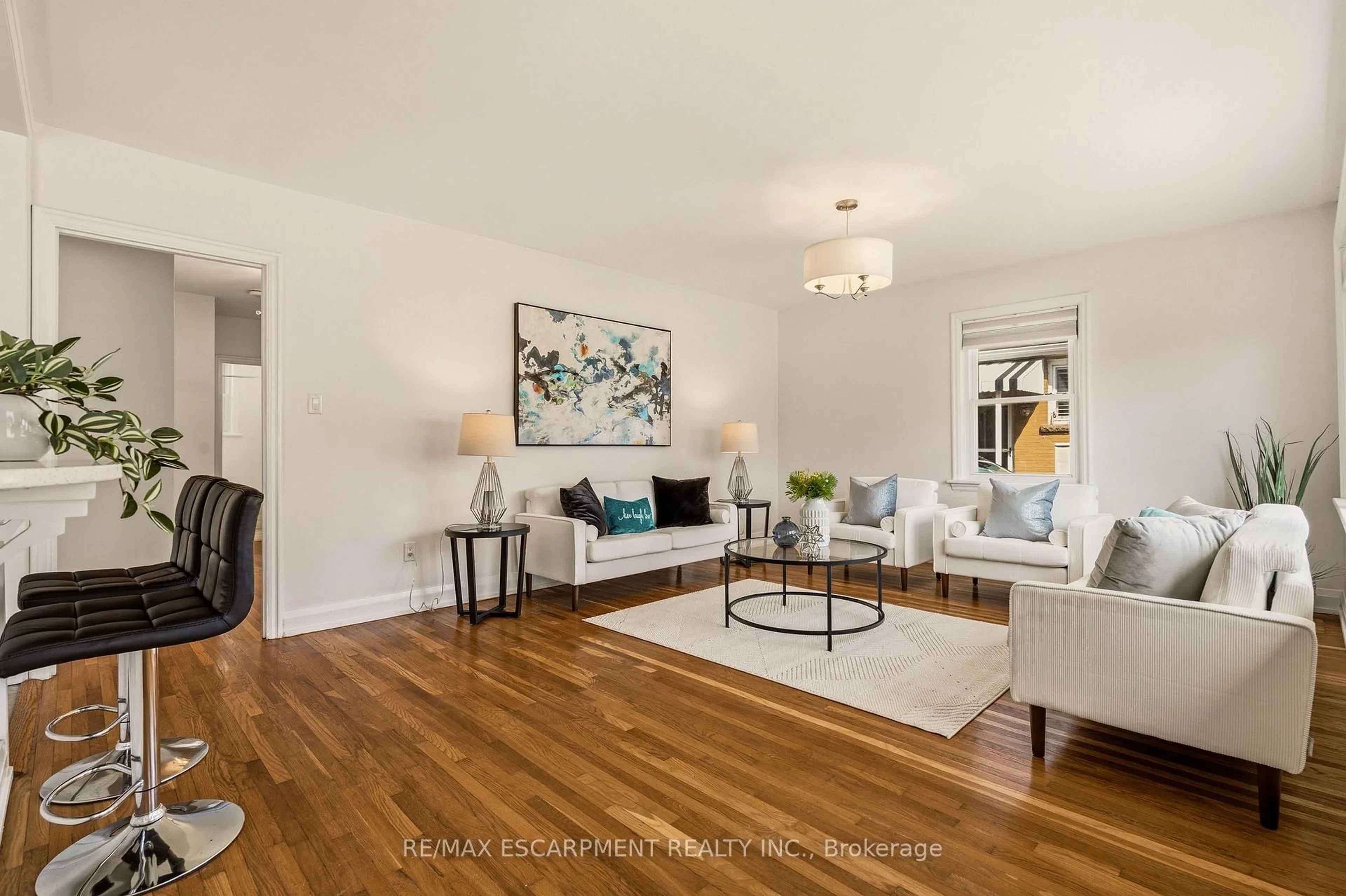 Living room with furniture, wood/laminate floor for 31 CAMERON Ave, Hamilton Ontario L9H 1P6