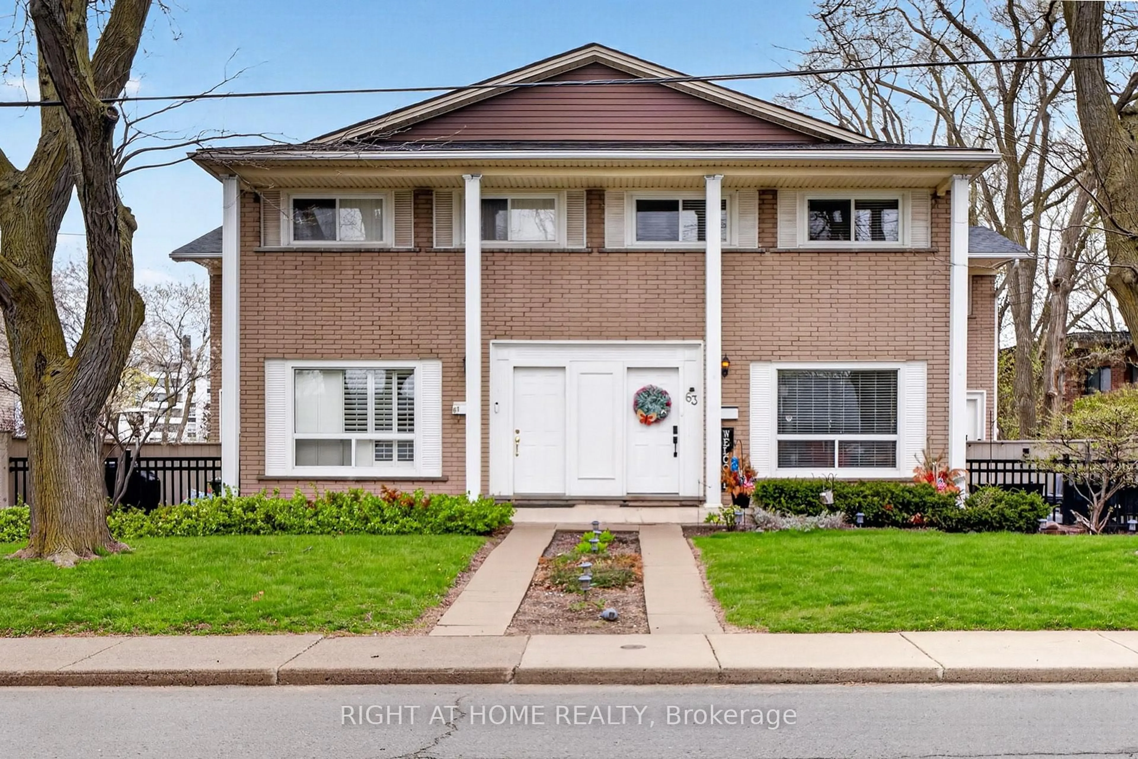 Home with brick exterior material, street for 65 Woodman Dr, Hamilton Ontario L8K 4E2