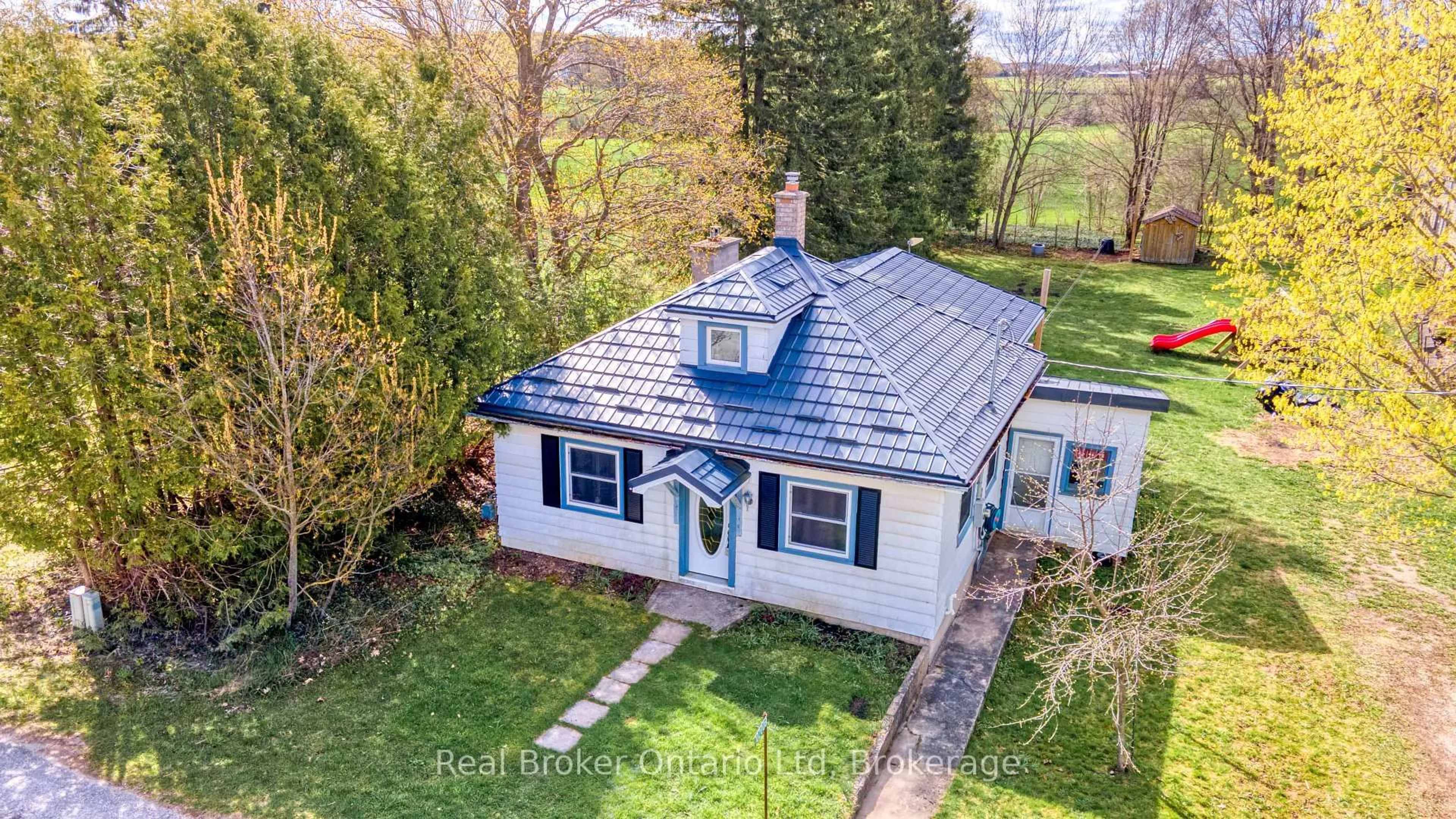 A pic from outside/outdoor area/front of a property/back of a property/a pic from drone, street for 102008 Grey 5 Rd, Georgian Bluffs Ontario N4K 5N5