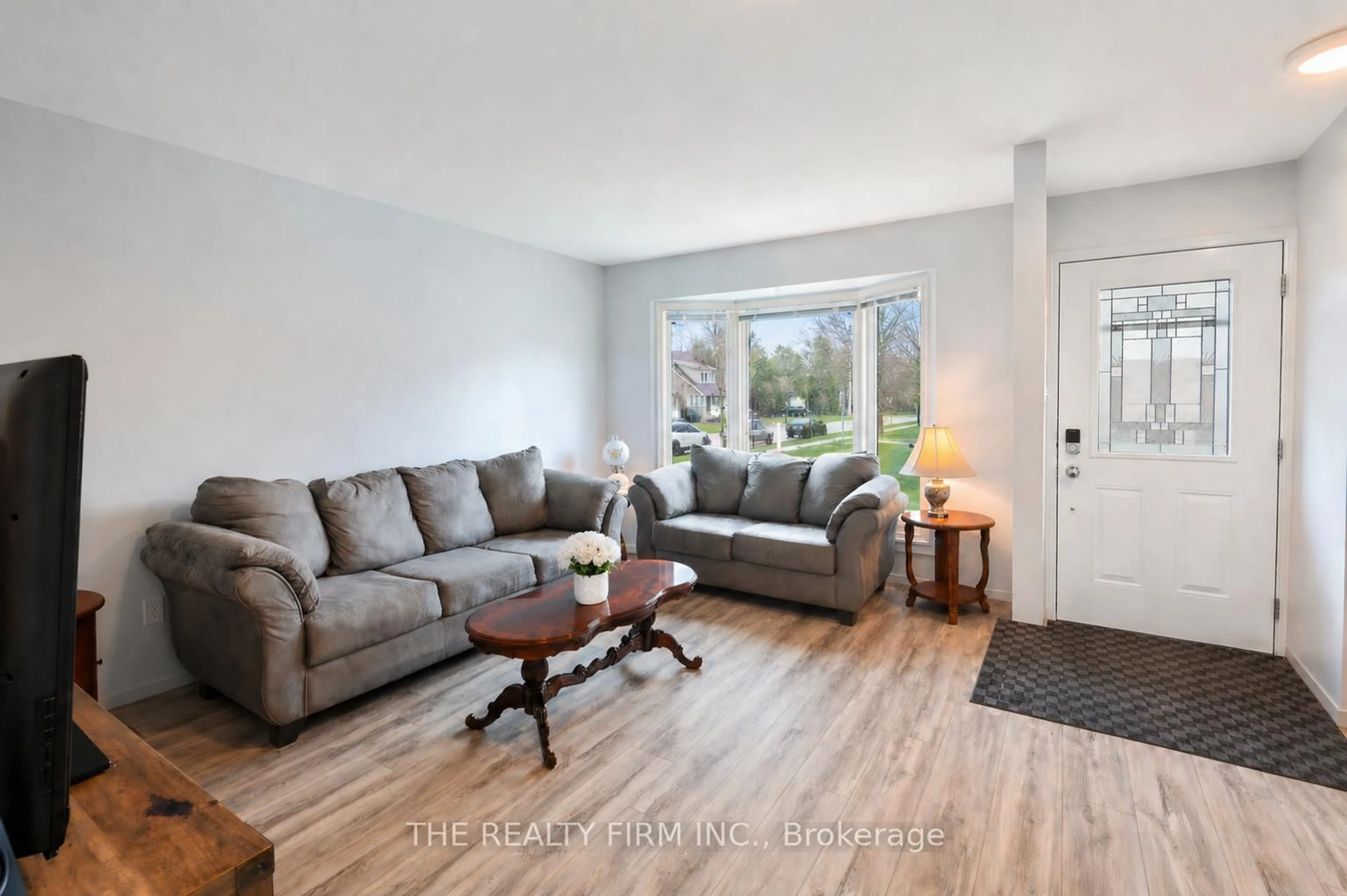Living room with furniture, wood/laminate floor for 40 Burslem St #1, London East Ontario N5W 2V7