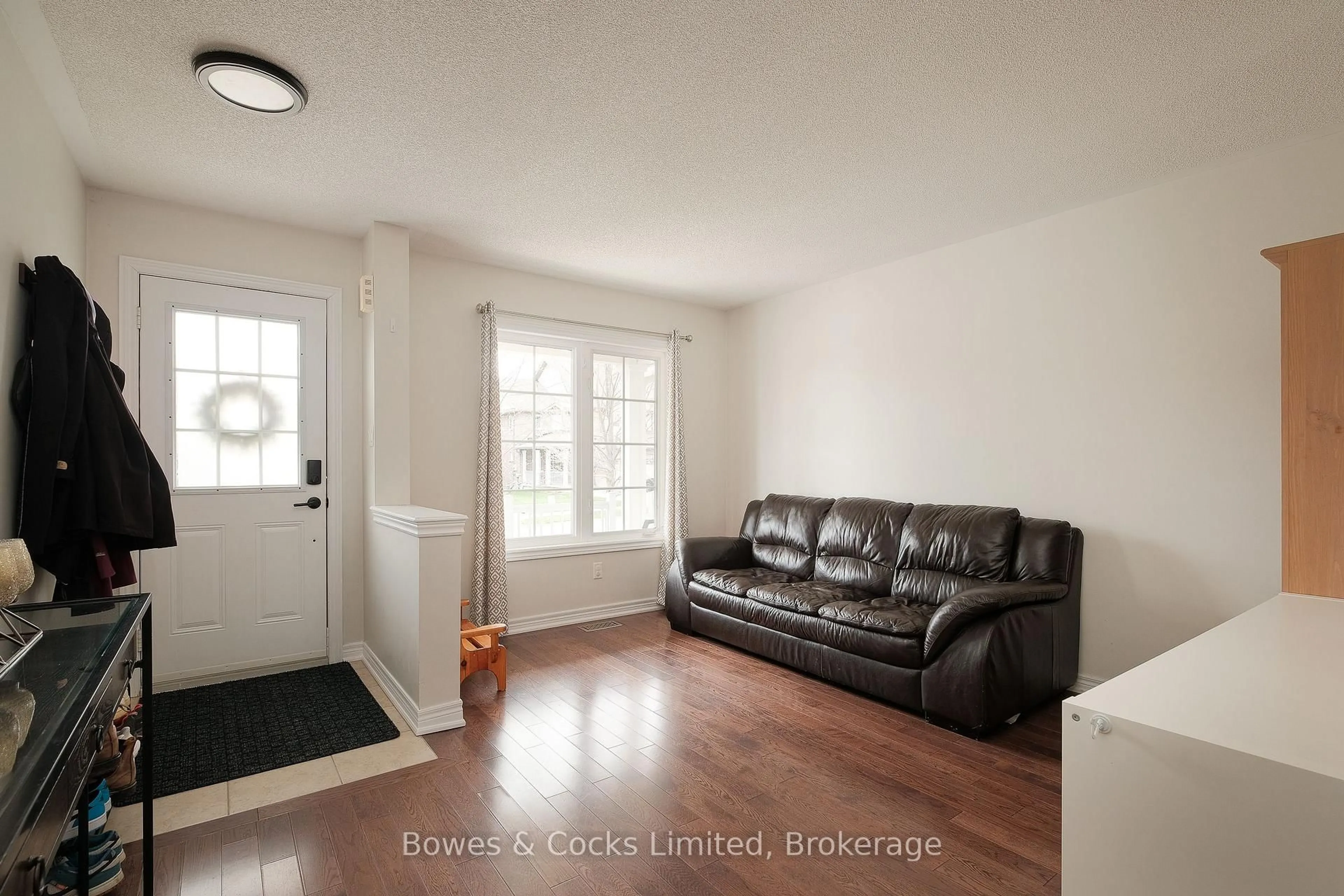 Living room with furniture, wood/laminate floor for 219 Louden Terr, Peterborough Ontario K9J 0H2