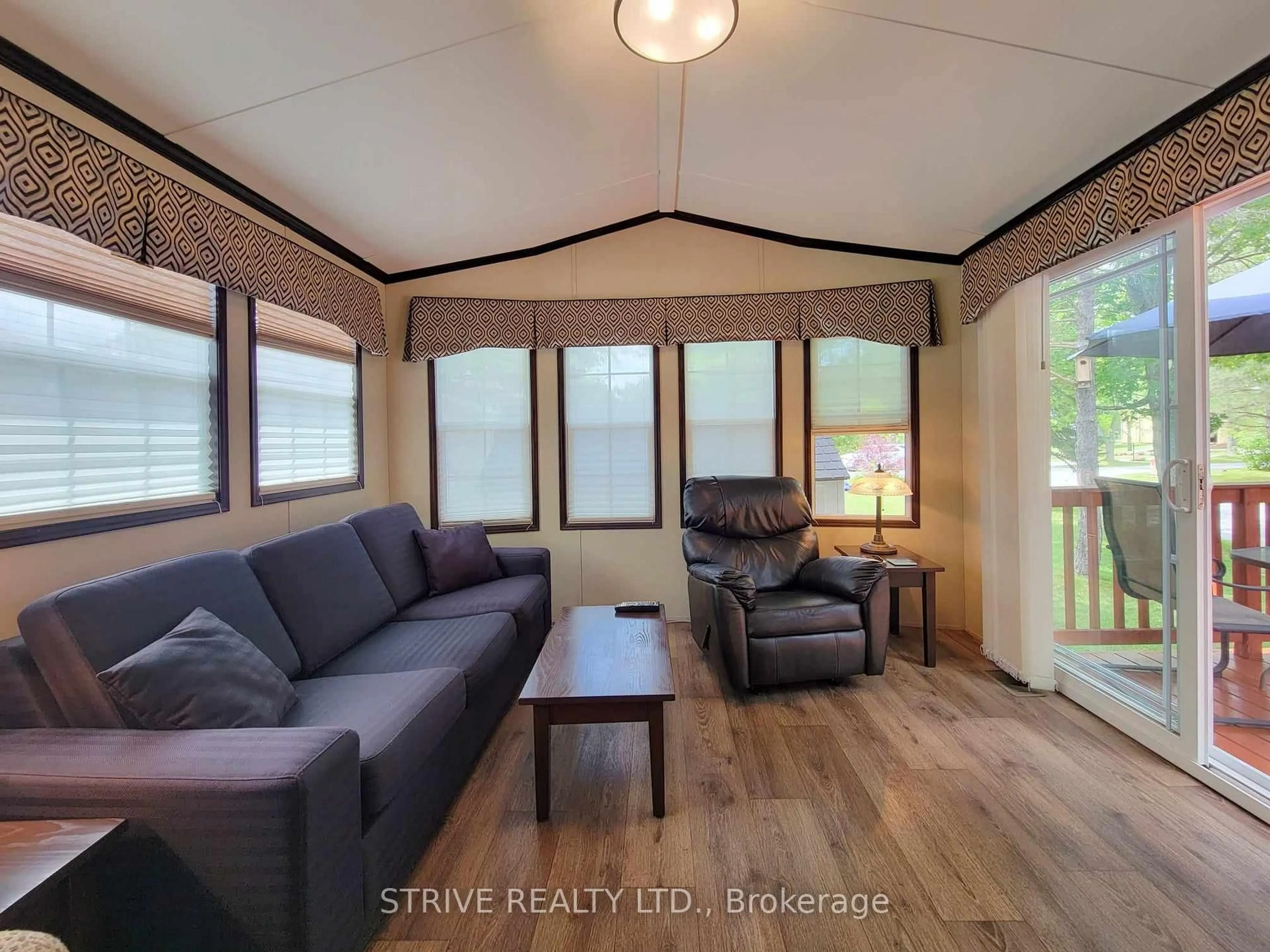 Living room with furniture, wood/laminate floor for 3-2152 County Rd 36 Rd, Kawartha Lakes Ontario K0M 1L0