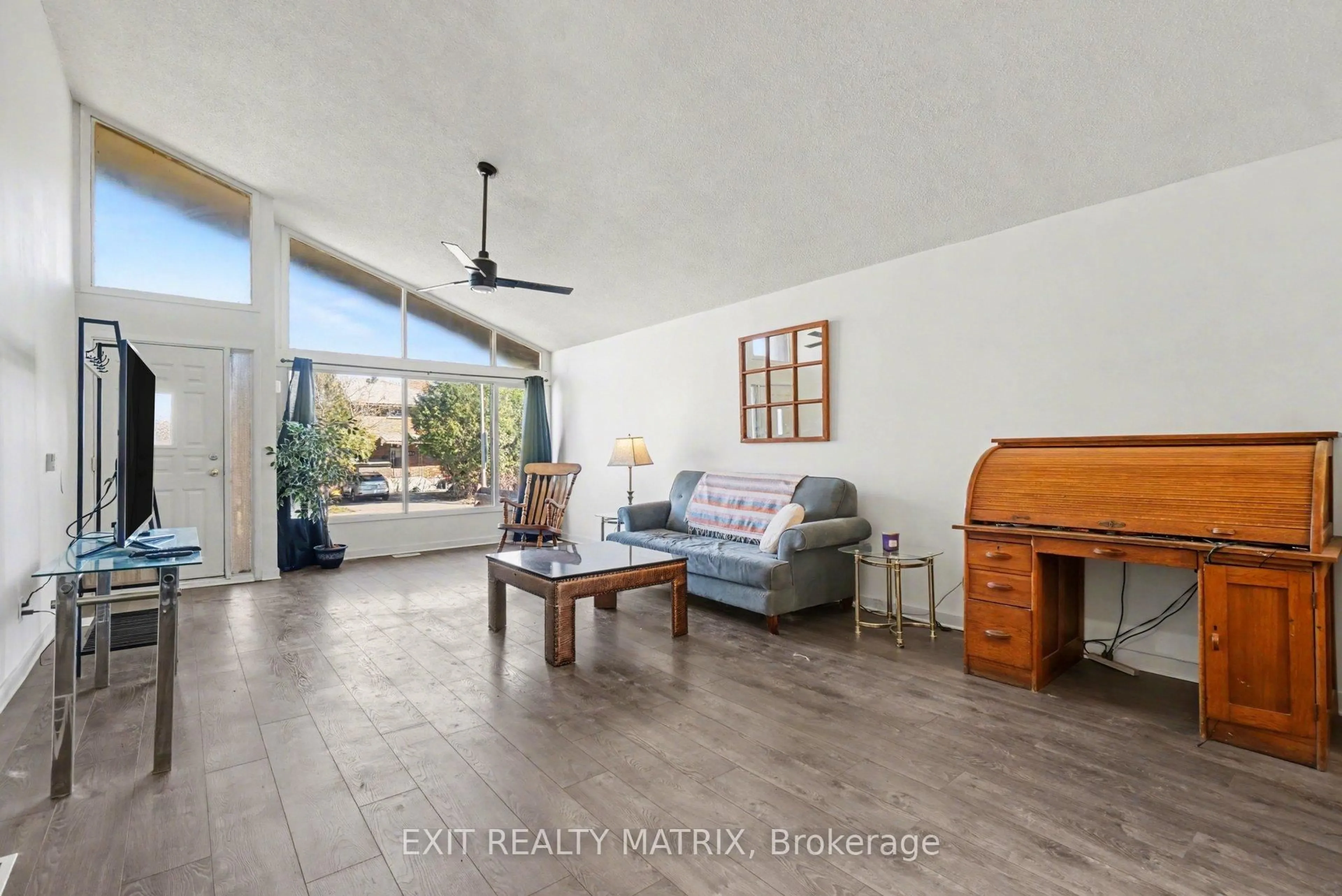 Living room with furniture, wood/laminate floor for 1864 Lenester Ave, Ottawa Ontario K2A 3W8