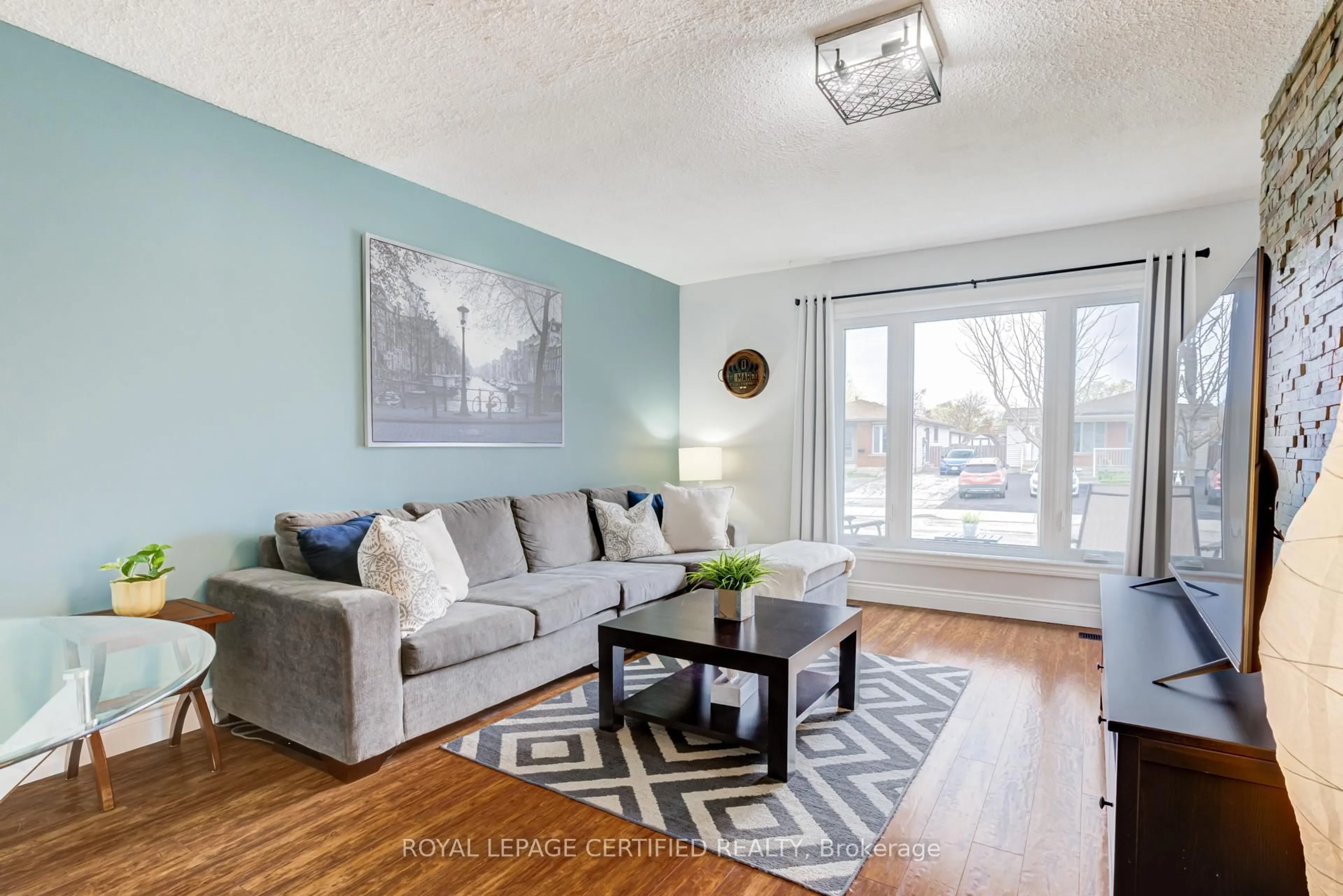 Living room with furniture, wood/laminate floor for 27 Lambert St, Hamilton Ontario L8V 4N6