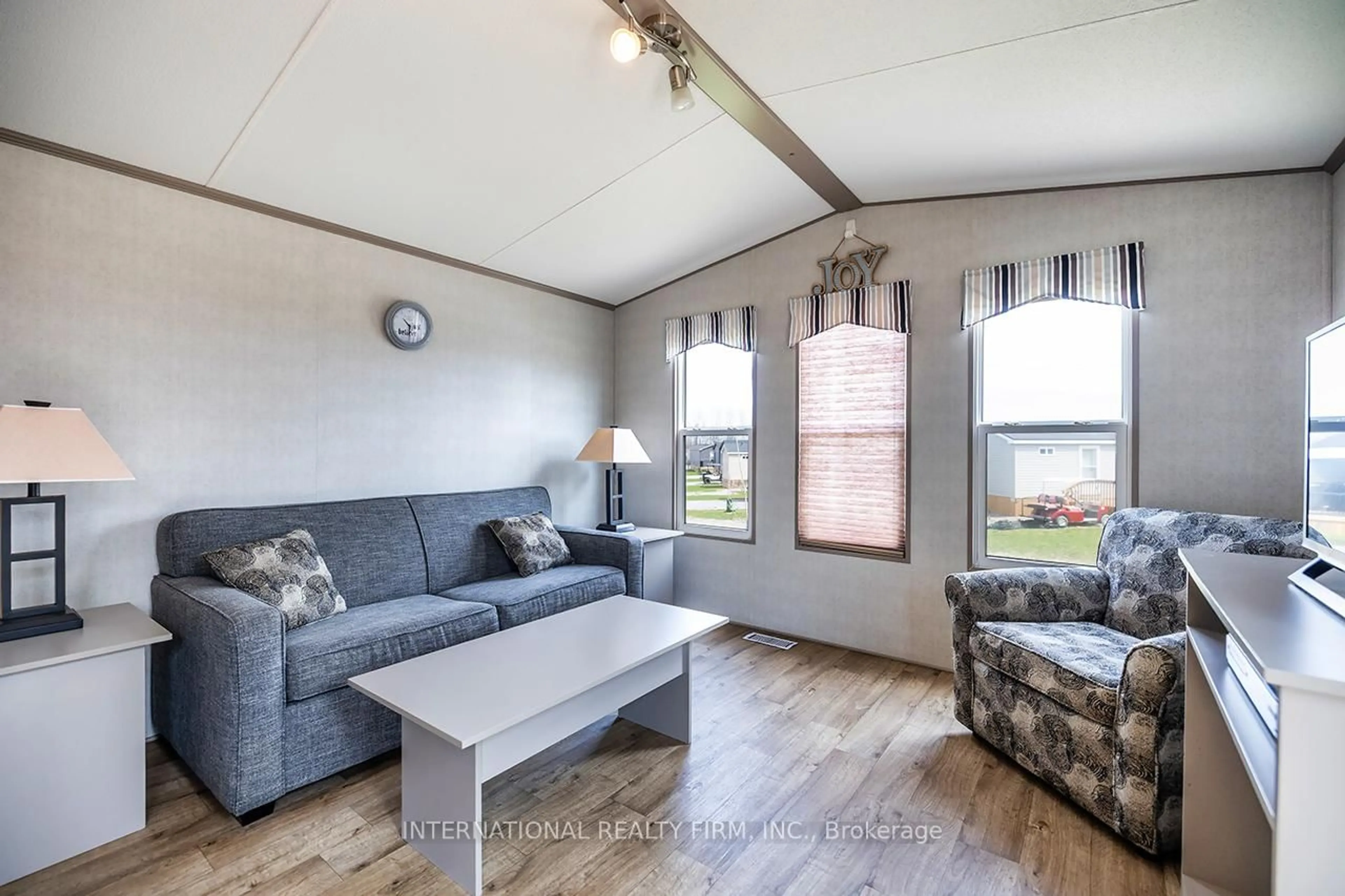 Living room with furniture, wood/laminate floor for 34 Glen Abby, Otonabee-South Monaghan Ontario K0L 2G0