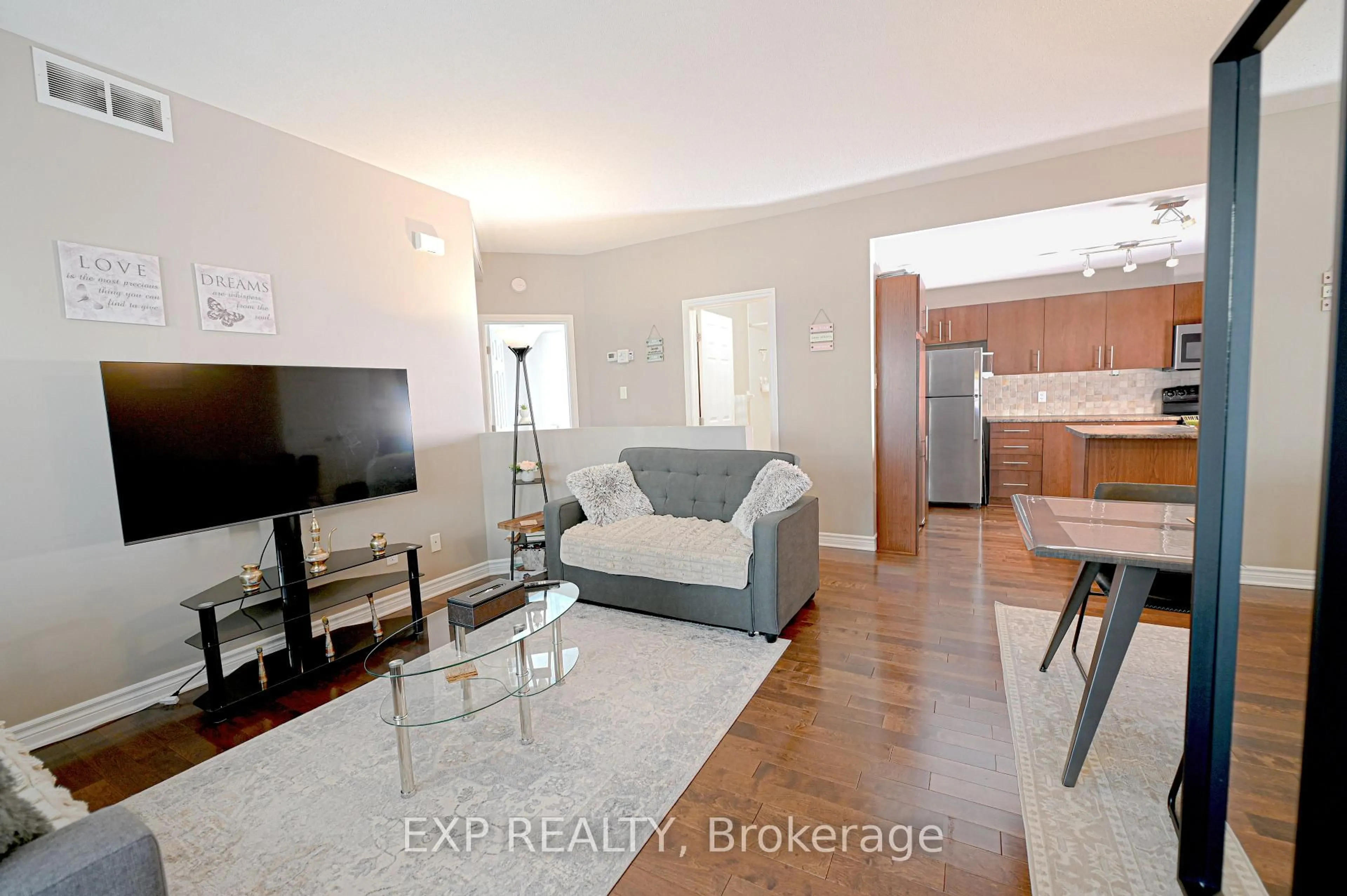 Living room with furniture, wood/laminate floor for 1113 STITTSVILLE MAIN St #G, Stittsville Ontario K2S 0C8
