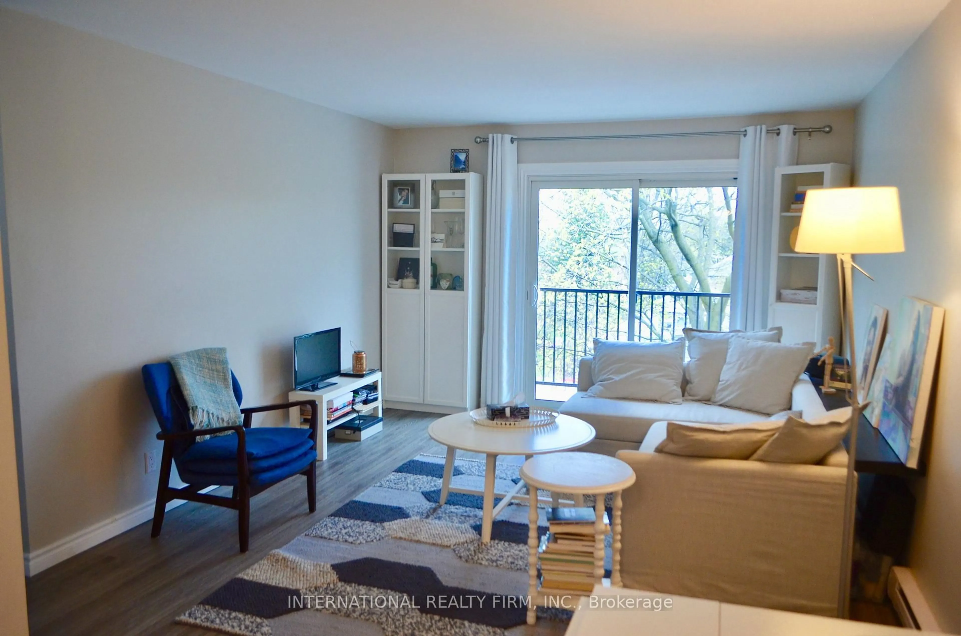 Living room with furniture, wood/laminate floor for 25 College St #407, Belleville Ontario K8P 2E3