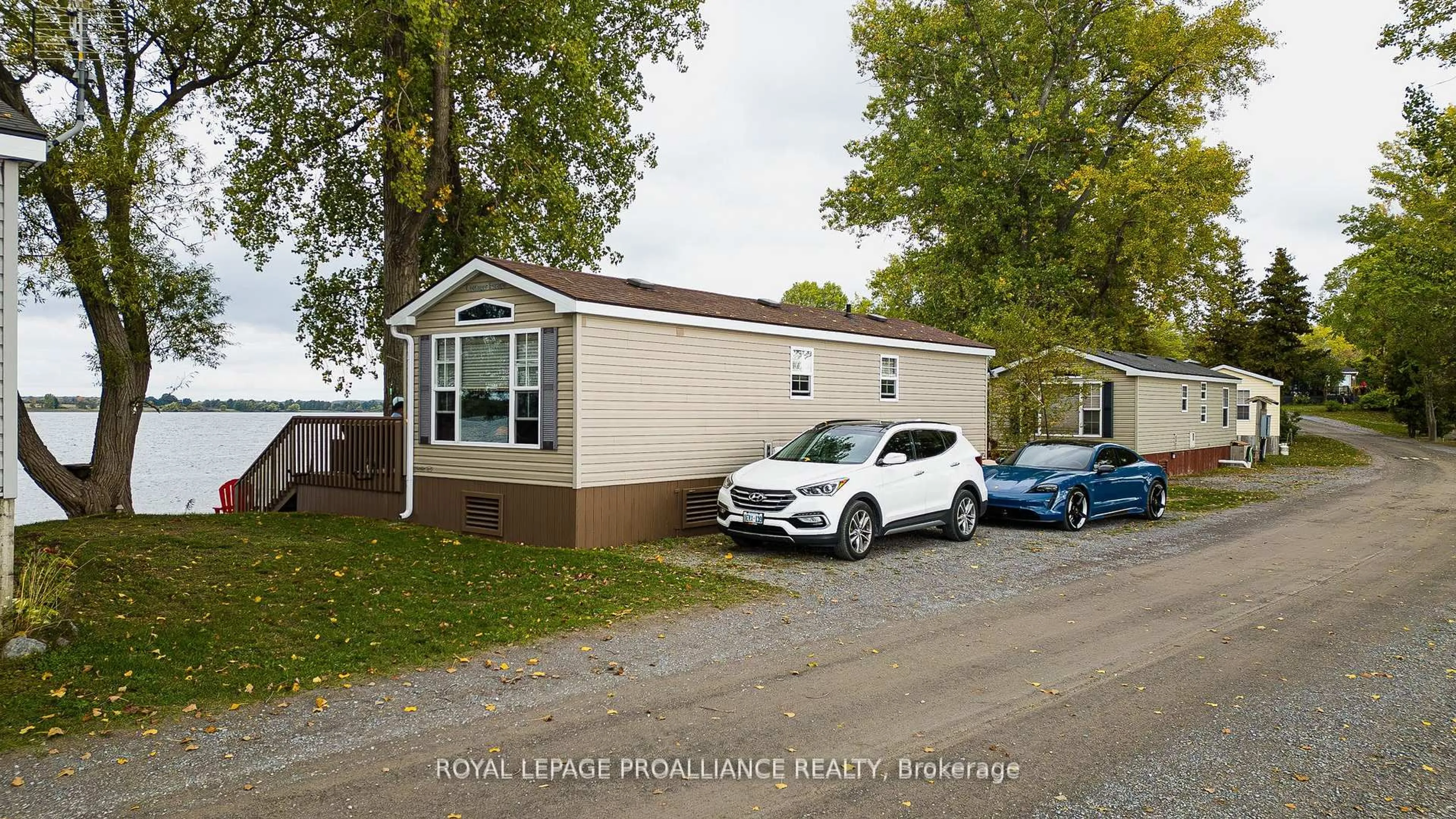 Home with vinyl exterior material, street for 486 Cty Rd 18- 64 Cherry Beach Lane, Prince Edward County Ontario K0K 2T0
