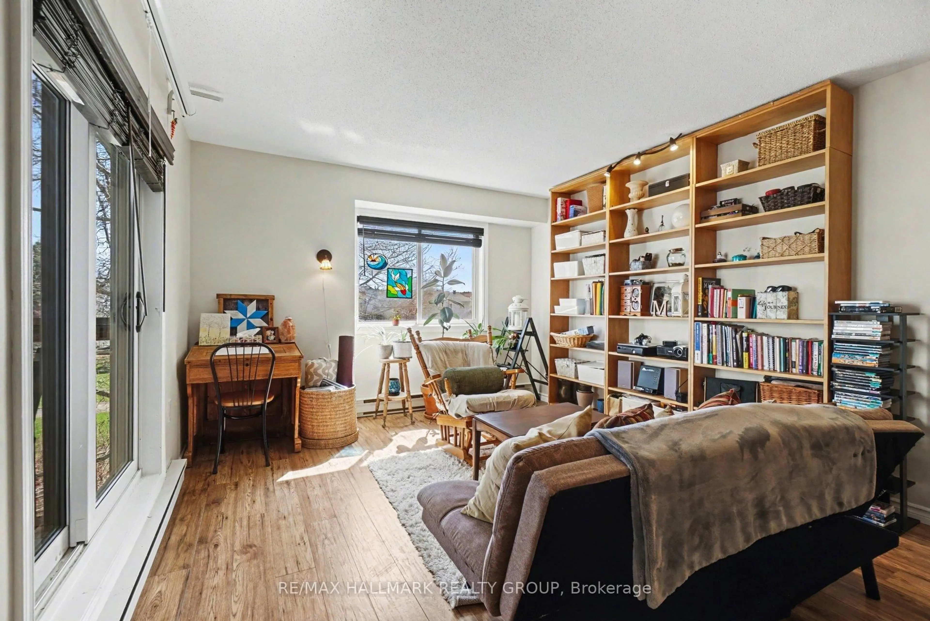 Living room with furniture, wood/laminate floor for 266 Lorry Greenberg Dr #203, Ottawa Ontario K1T 3J9
