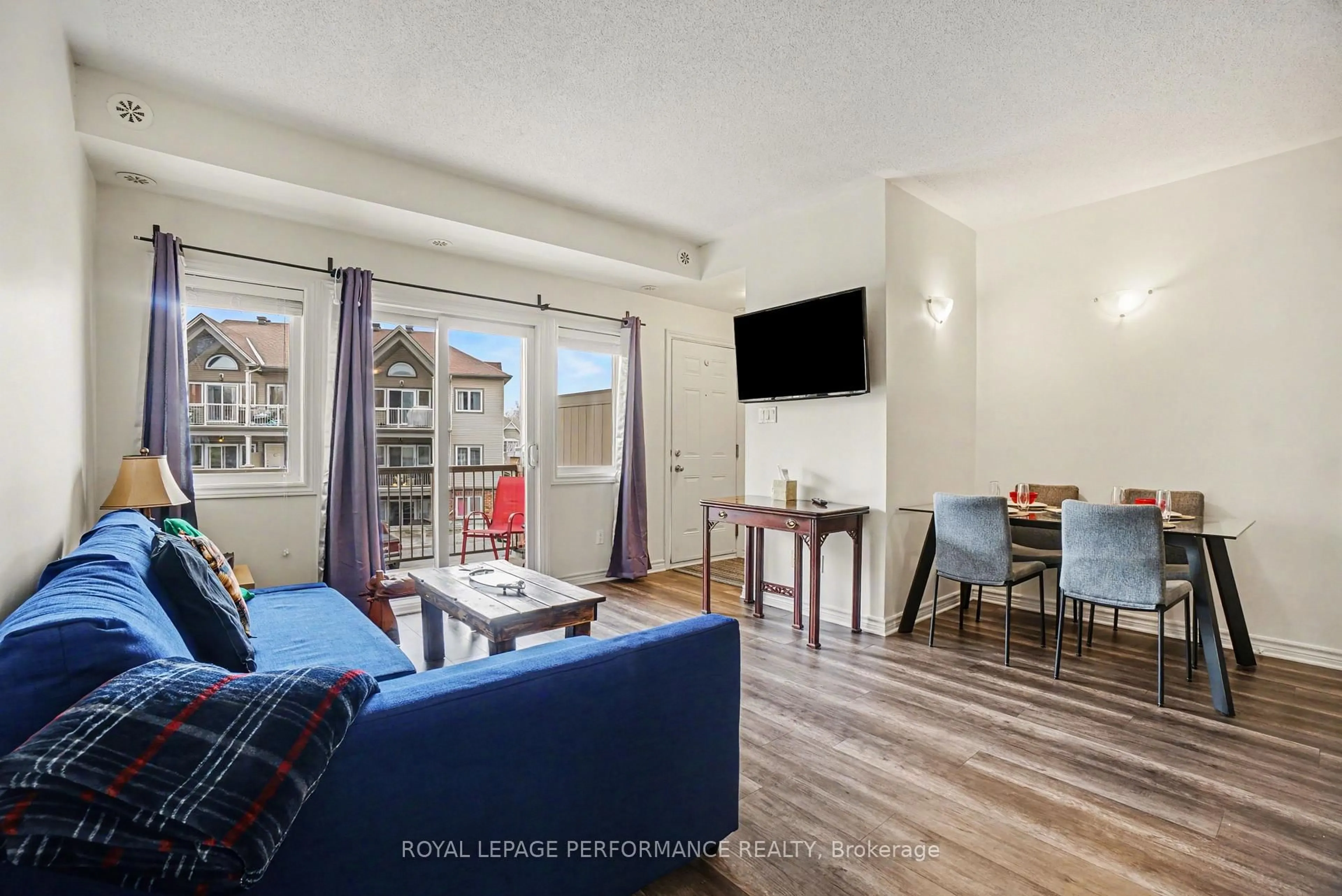 Living room with furniture, wood/laminate floor for 151 Mocha Private #F, Ottawa Ontario K1T 0K5
