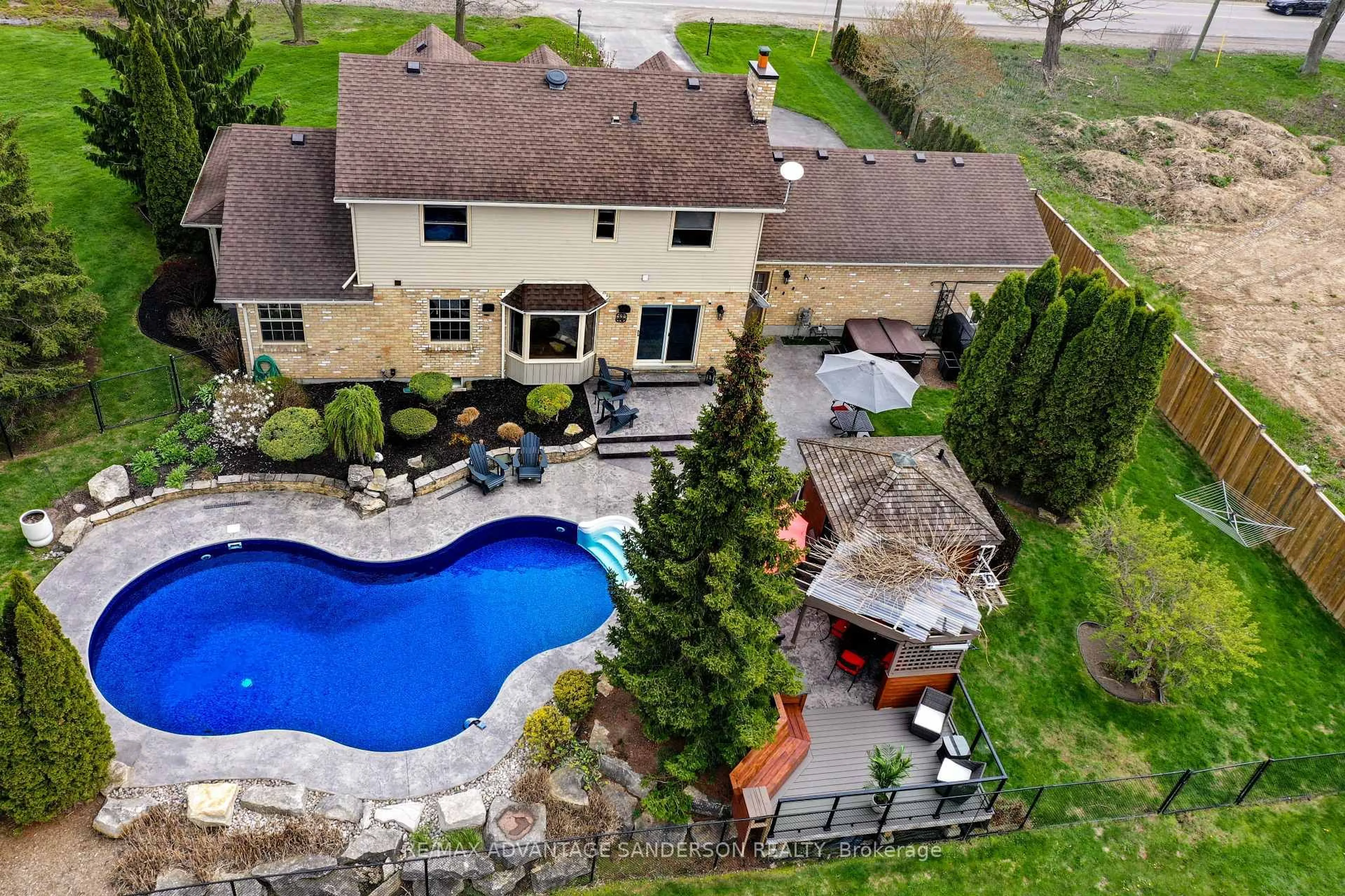 A pic from outside/outdoor area/front of a property/back of a property/a pic from drone, water/lake/river/ocean view for 975 Sunningdale Rd, London North Ontario N6G 5B7