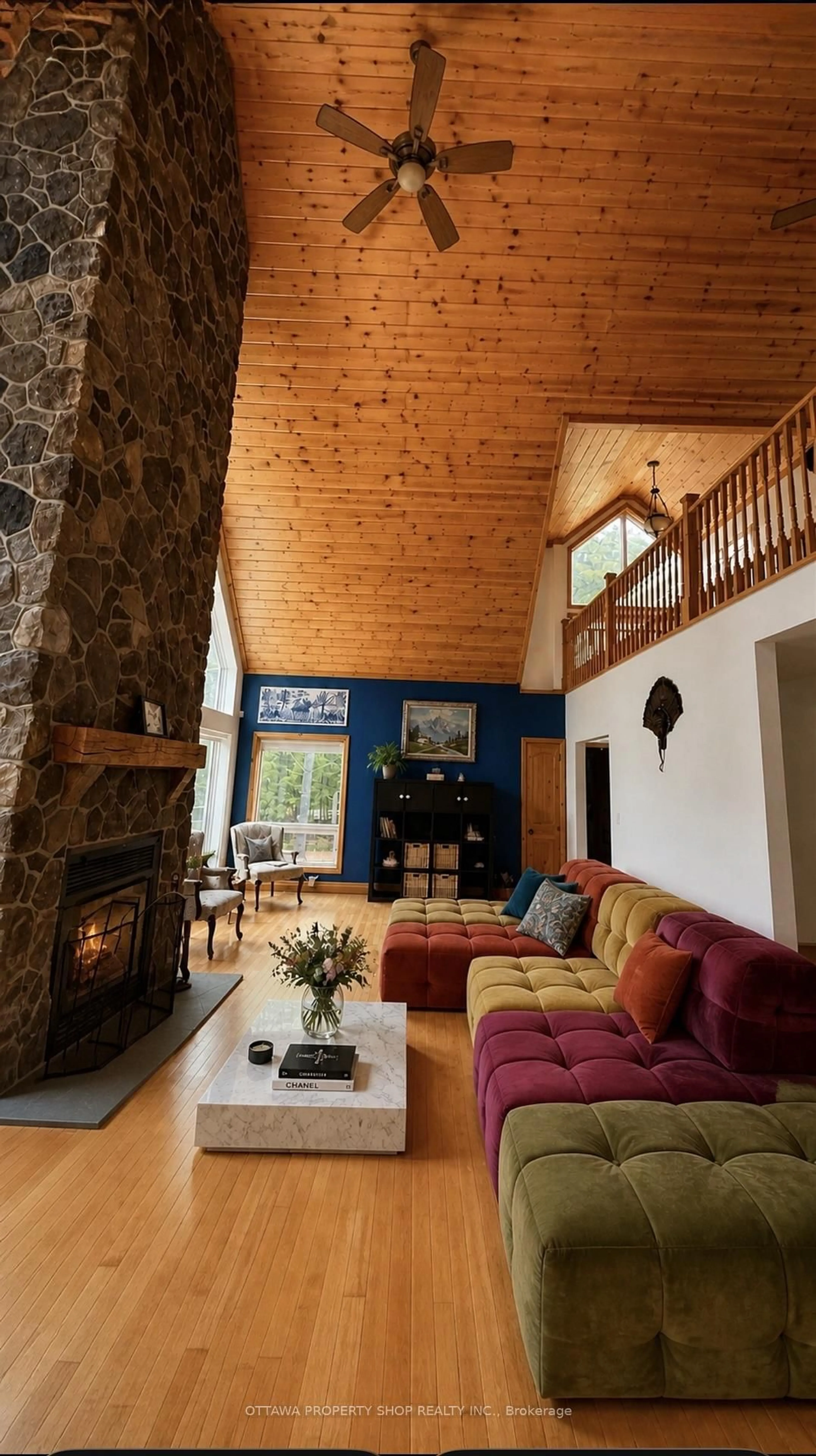 Living room with furniture, wood/laminate floor for 927 Spruce Ridge Rd, Carp Ontario K0A 1L0