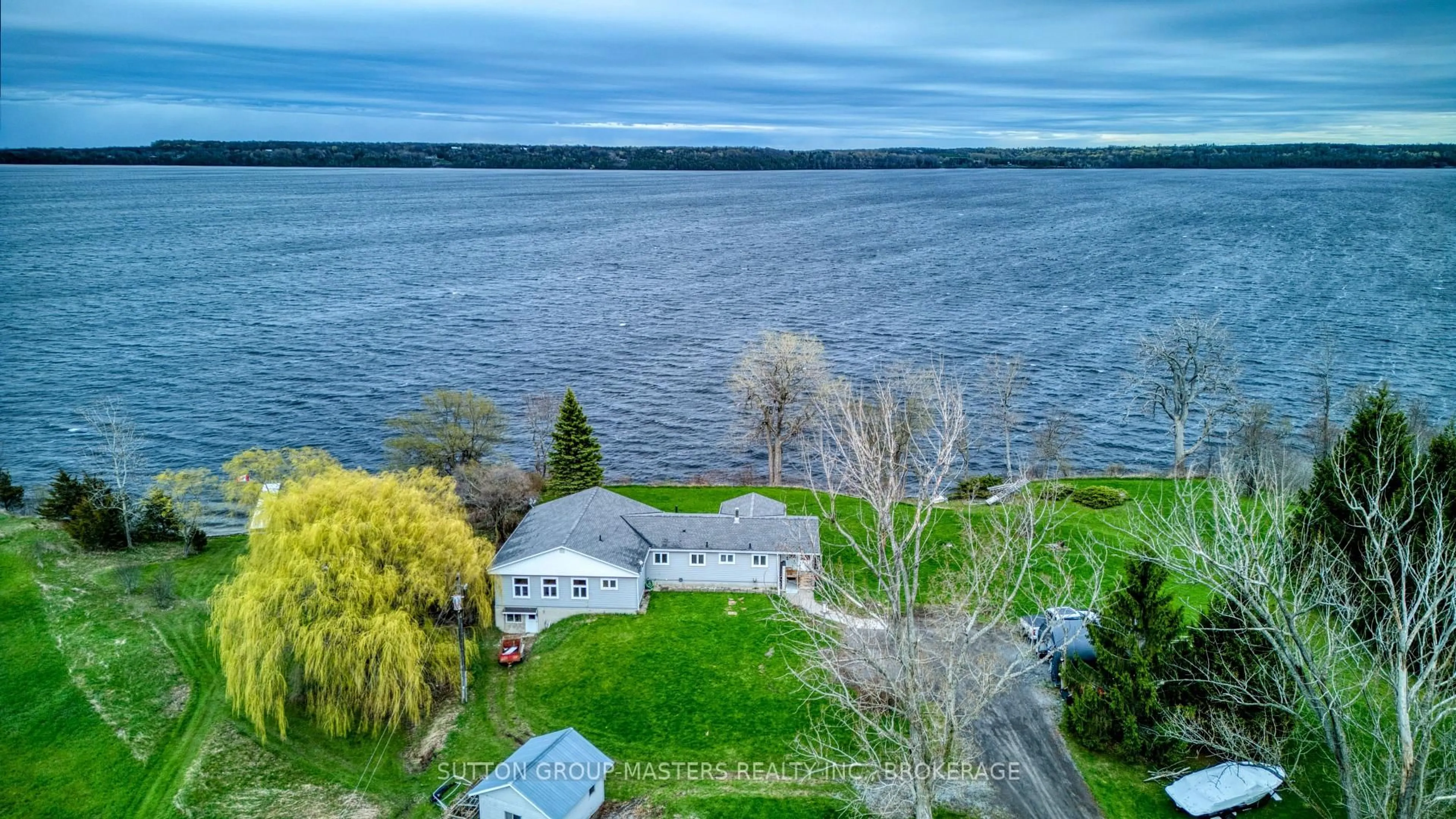 A pic from outside/outdoor area/front of a property/back of a property/a pic from drone, water/lake/river/ocean view for 9392 Highway 33 Highway, Bath Ontario K0H 1G0