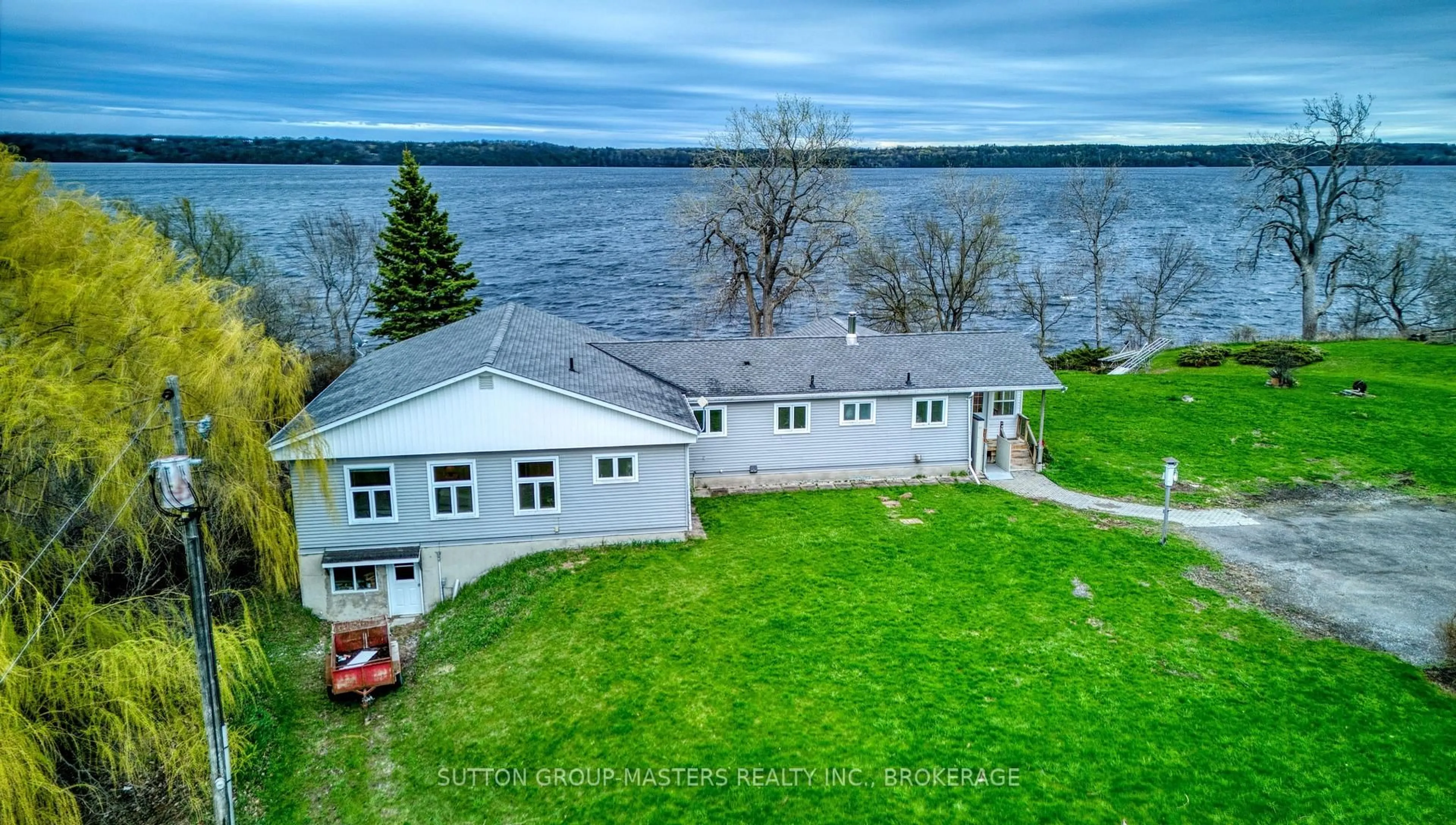 A pic from outside/outdoor area/front of a property/back of a property/a pic from drone, water/lake/river/ocean view for 9392 Highway 33 Highway, Bath Ontario K0H 1G0
