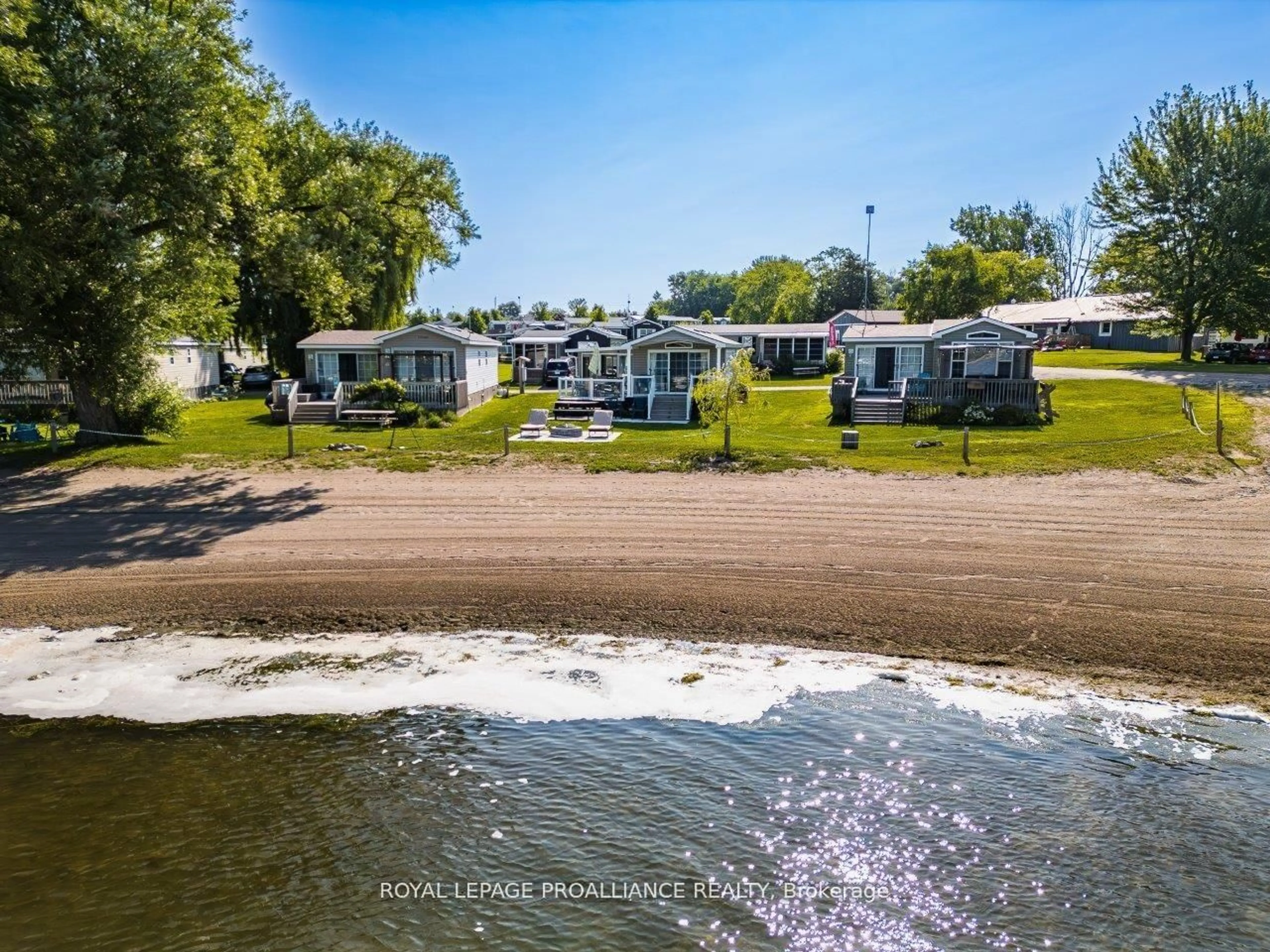 A pic from outside/outdoor area/front of a property/back of a property/a pic from drone, water/lake/river/ocean view for 486 Cty Rd 18 - 3 Beachview Lane, Prince Edward County Ontario K0K 1P0