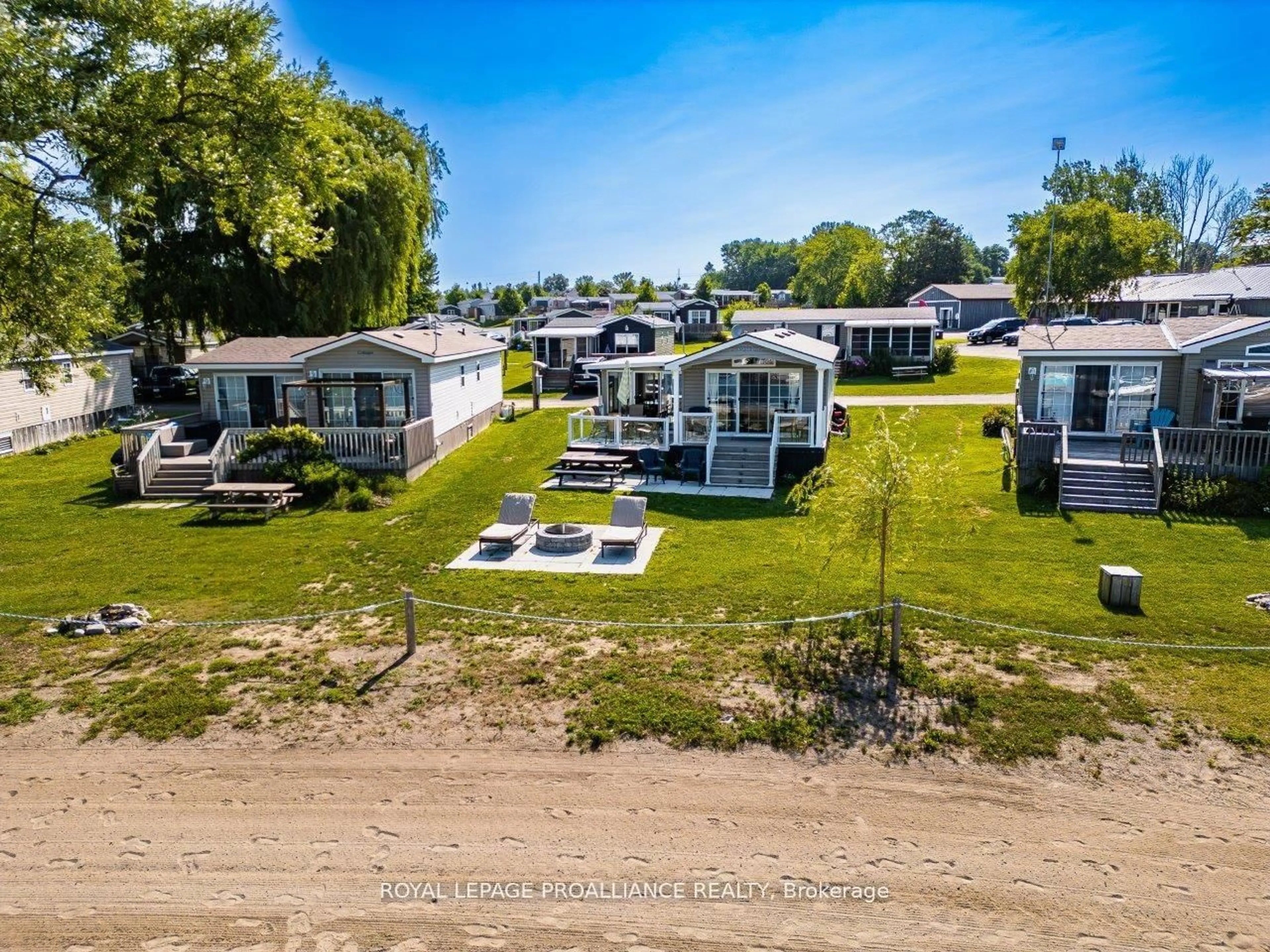 A pic from outside/outdoor area/front of a property/back of a property/a pic from drone, water/lake/river/ocean view for 486 Cty Rd 18 - 3 Beachview Lane, Prince Edward County Ontario K0K 1P0